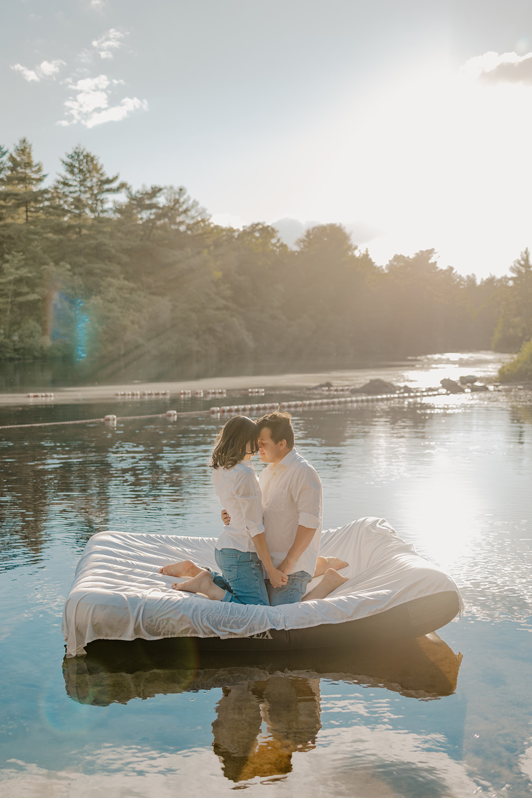 stunning couple pose on an air mattress together