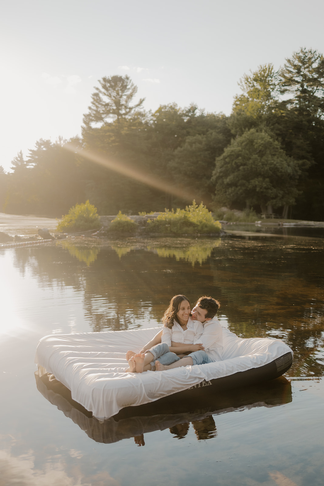 stunning couple pose on an air mattress together