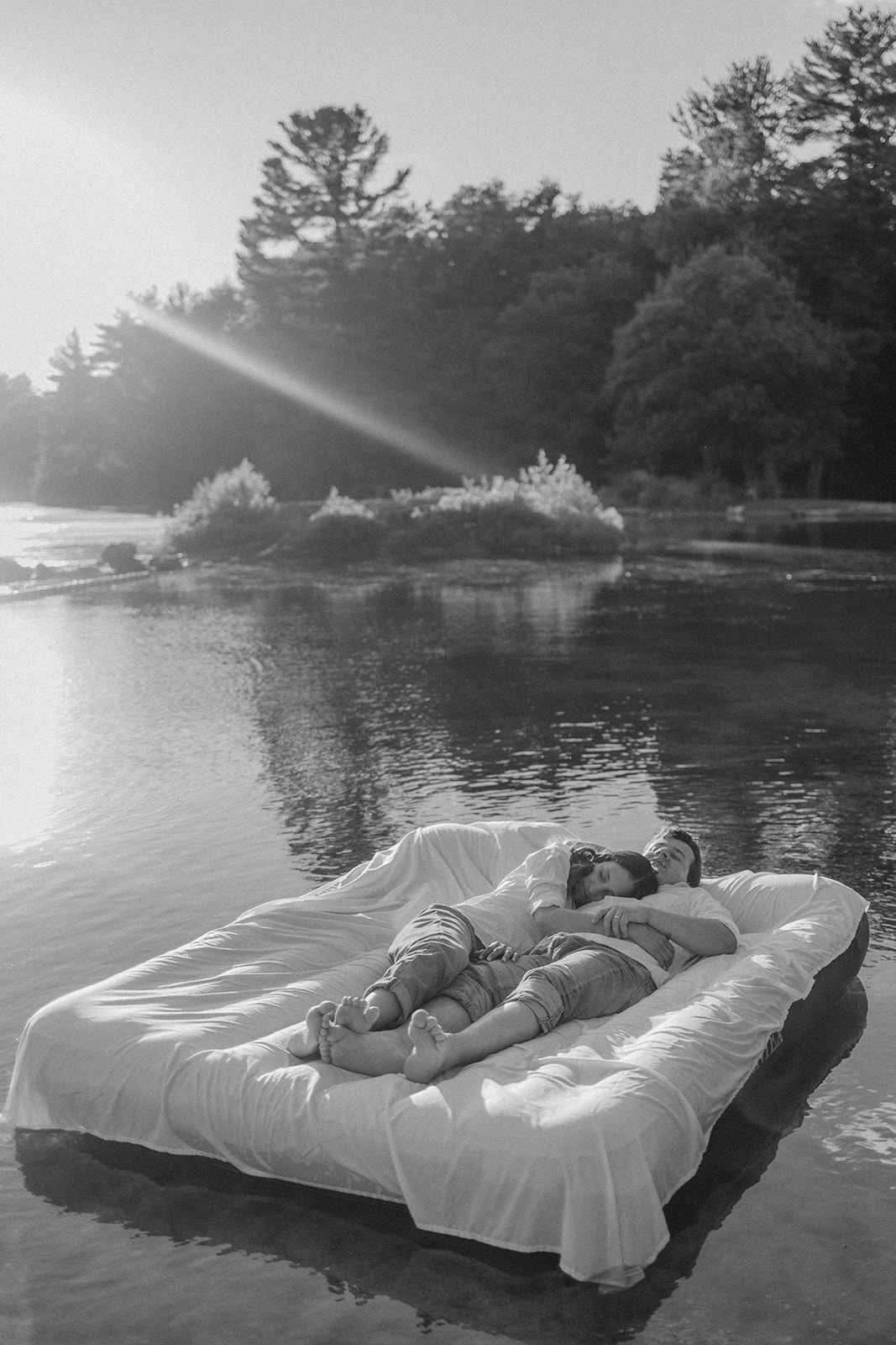 stunning couple pose on an air mattress together