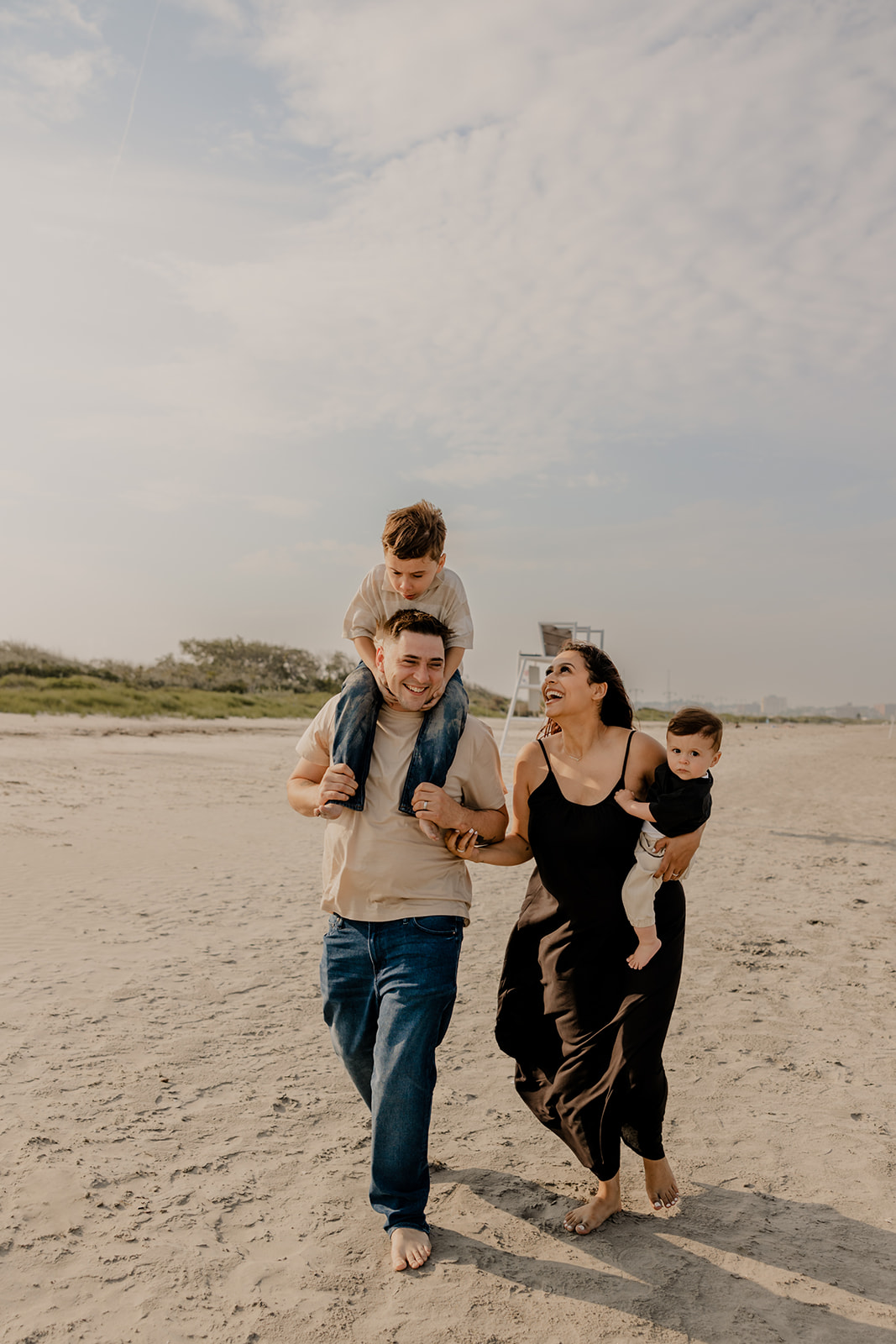 beautiful family poses together for a beach family photo session on the East Coast