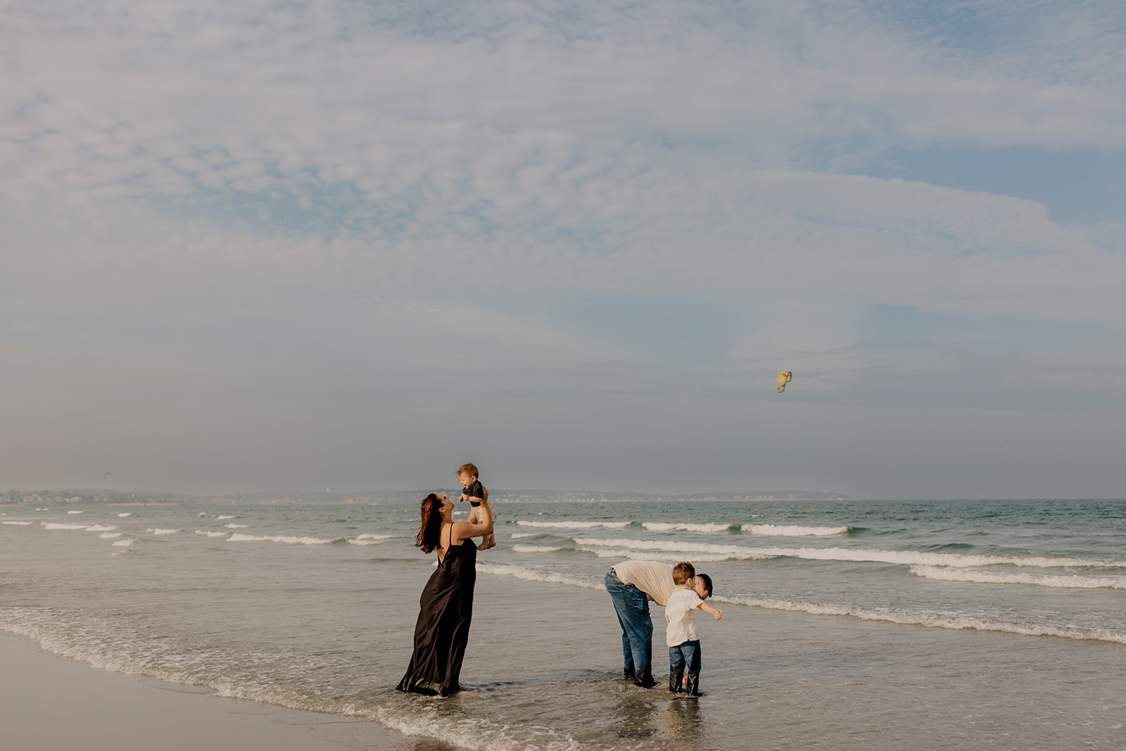 beautiful family poses together for a beach family photo session on the East Coast