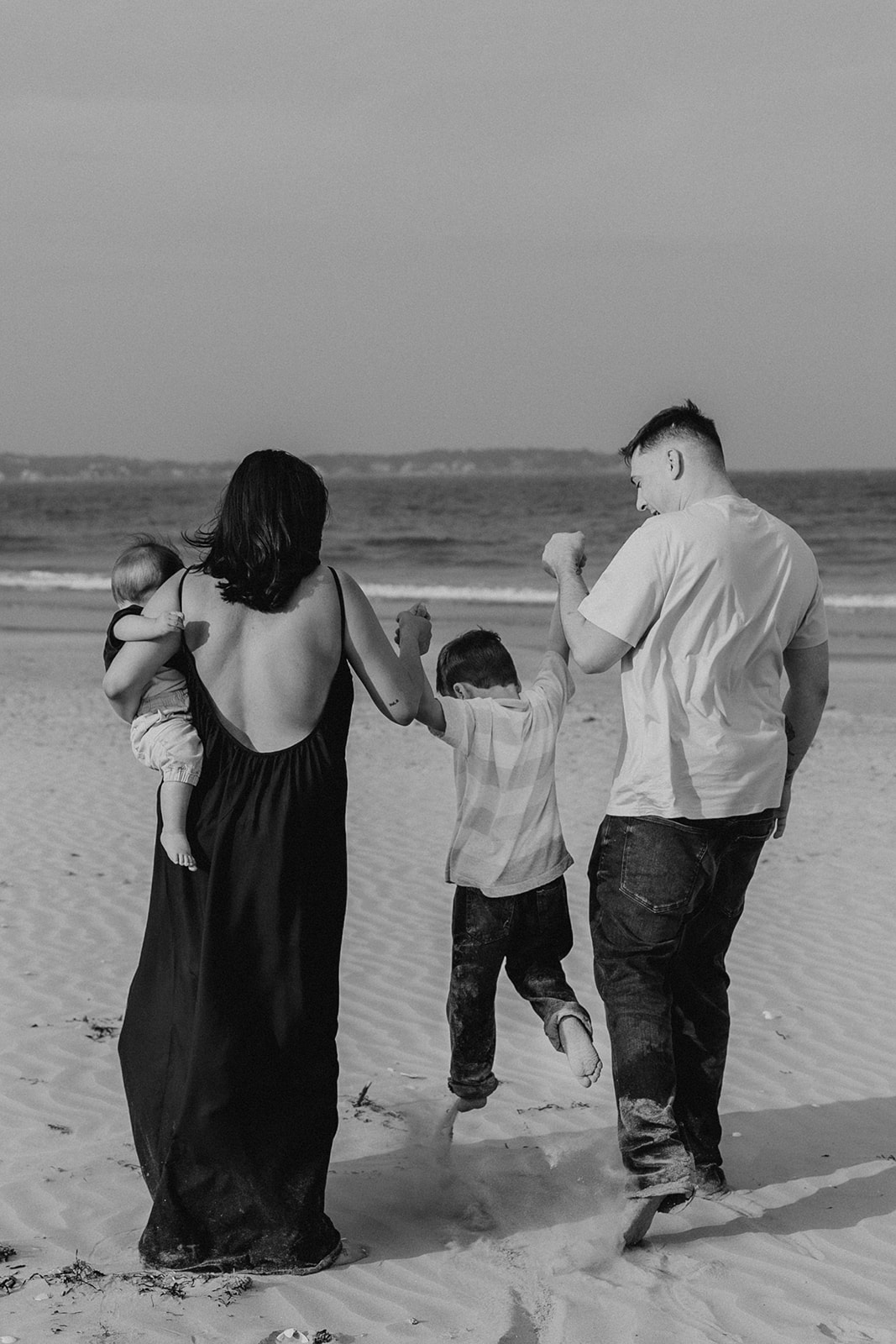 beautiful family poses together for a beach family photo session on the East Coast