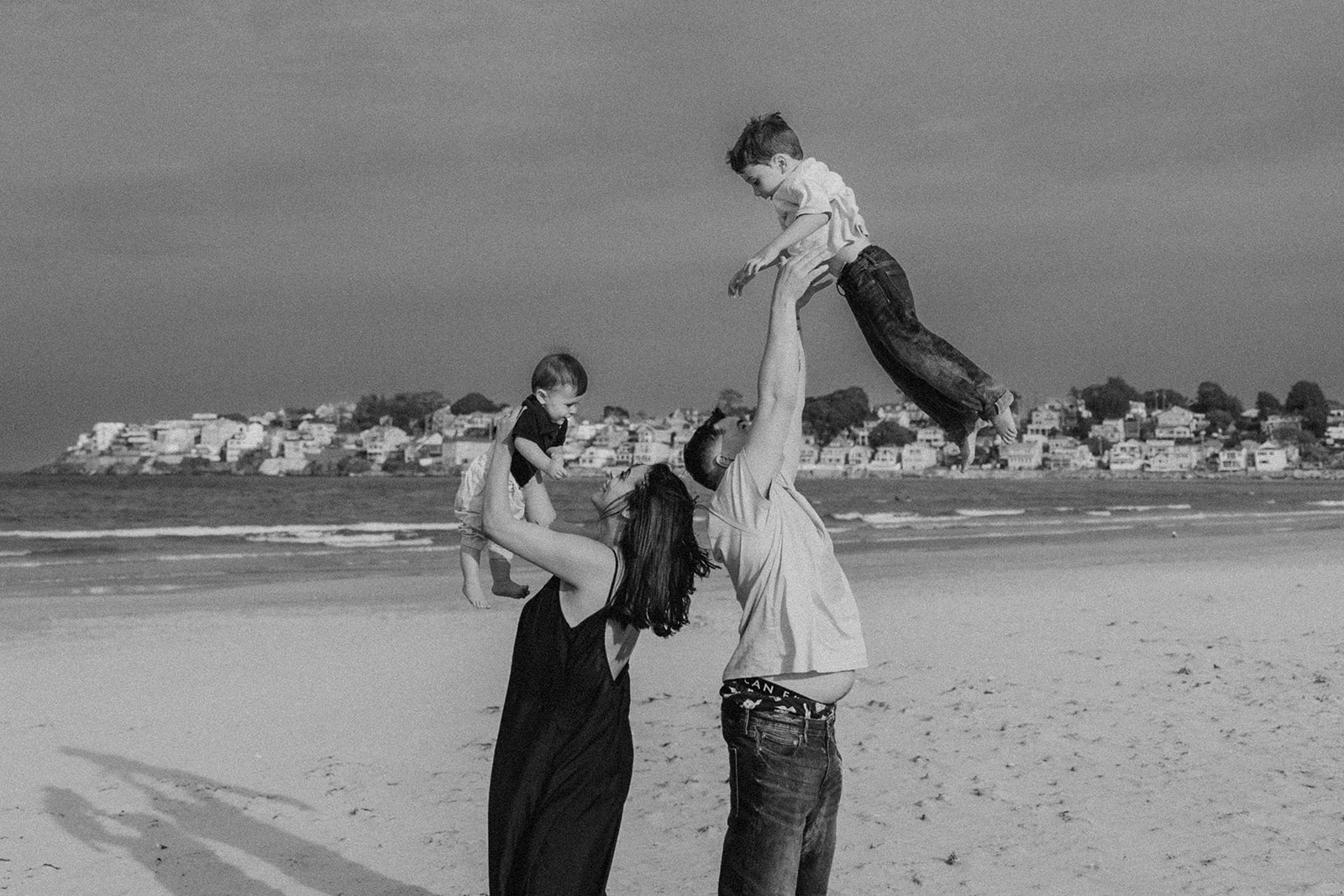 beautiful family poses together for a beach family photo session on the East Coast