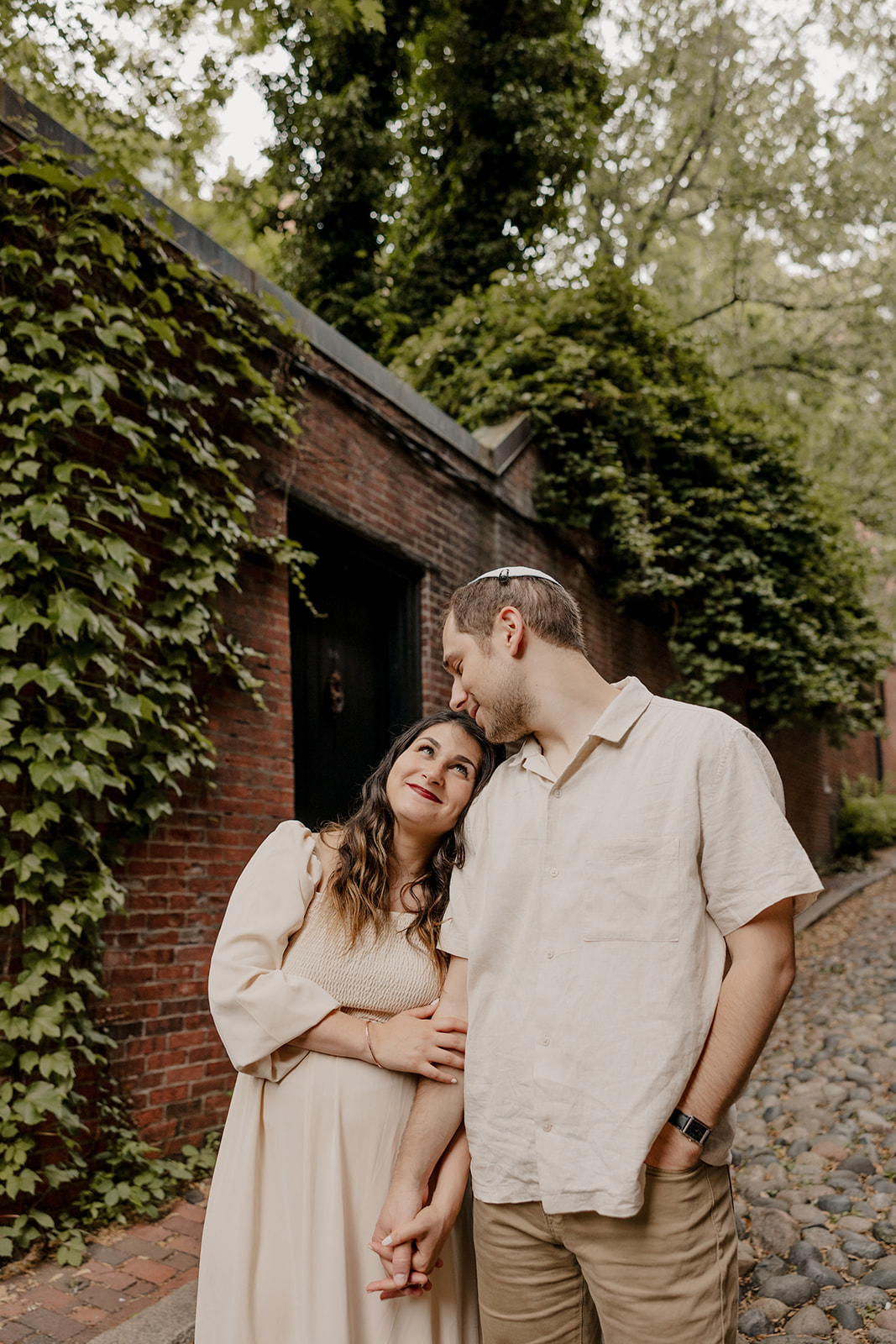 Beautiful couple pose together in a Boston garden, a perfect Boston engagement location