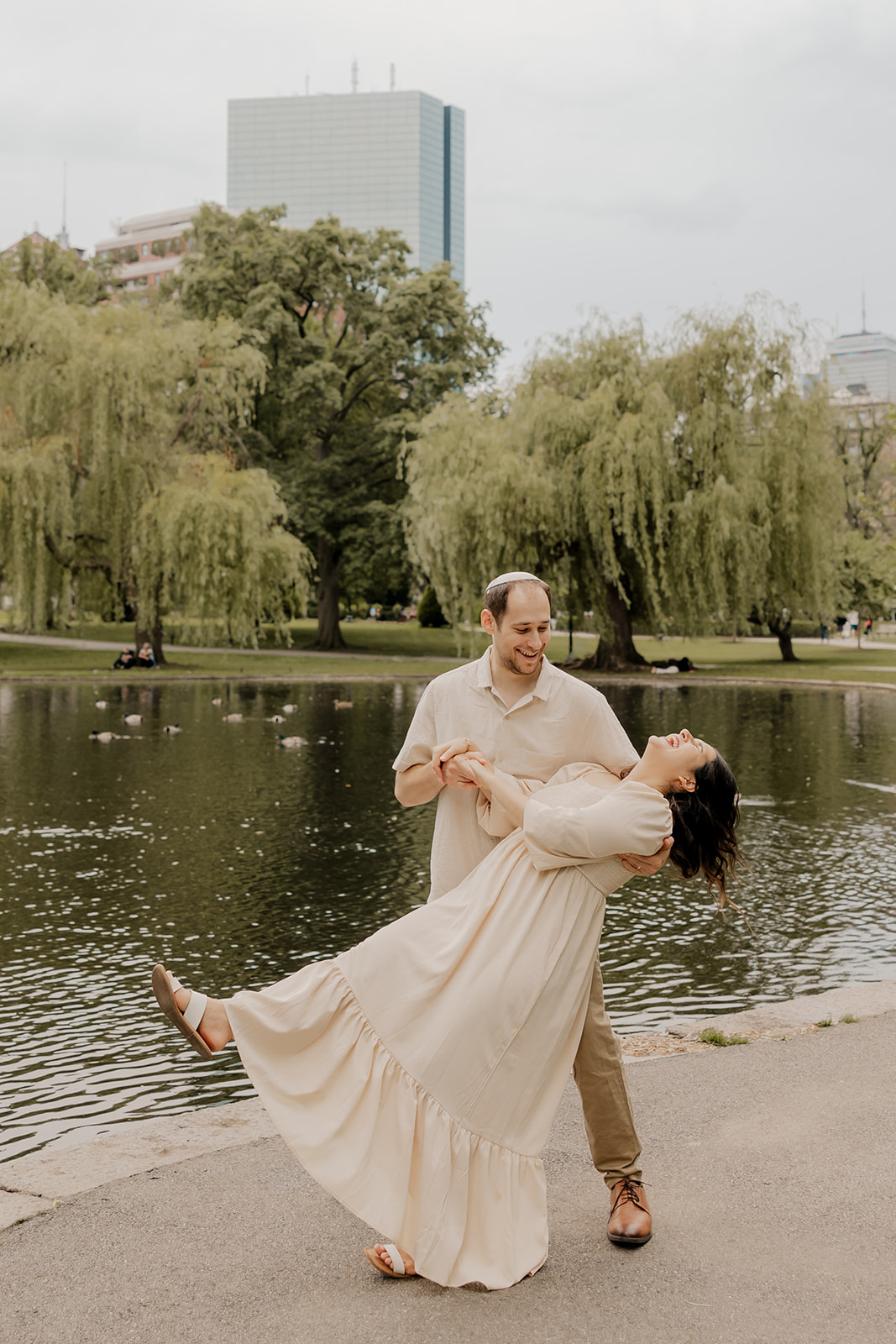 Beautiful couple pose together with Boston buildings behind them