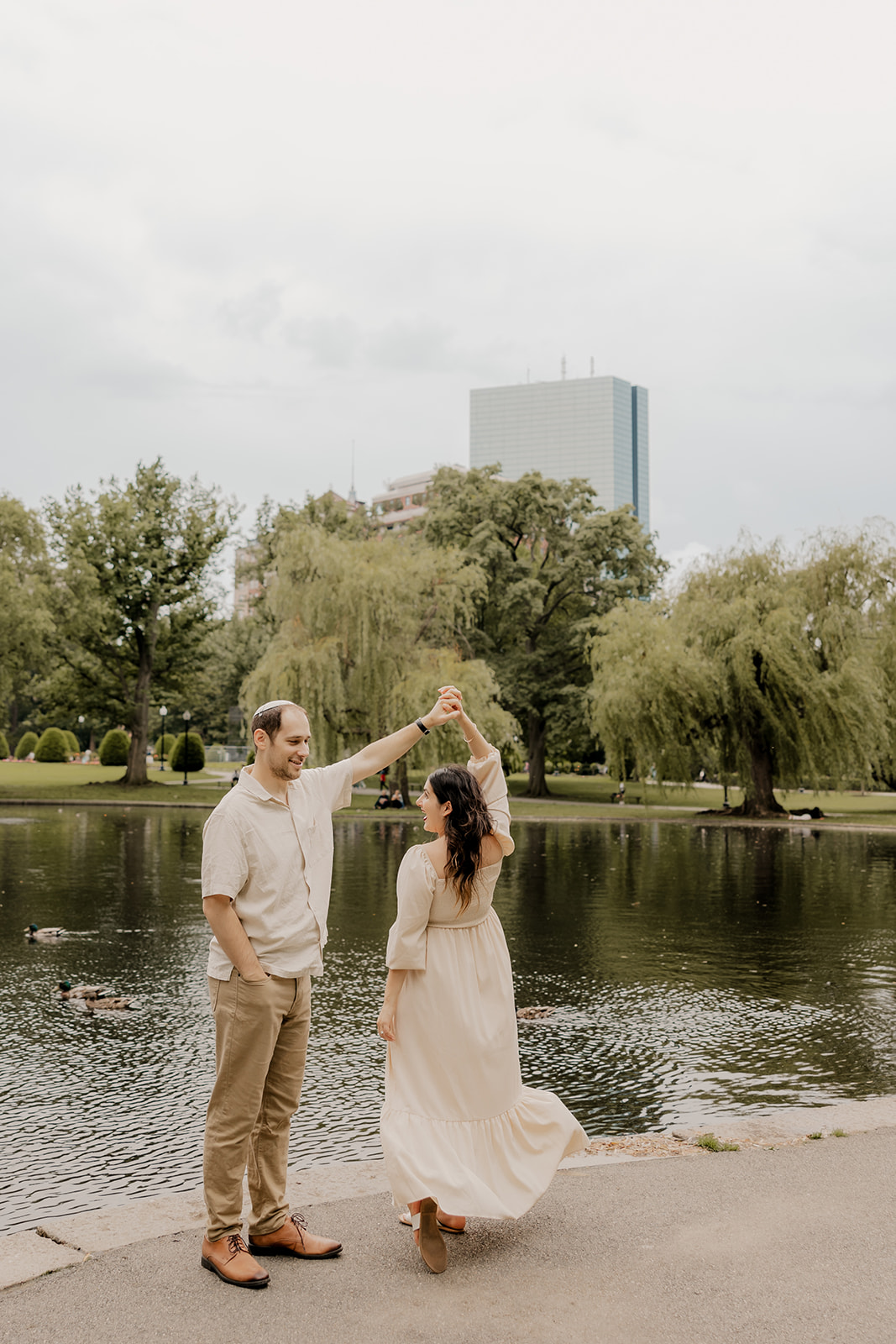 Beautiful couple pose together in a Boston garden, a perfect Boston engagement location