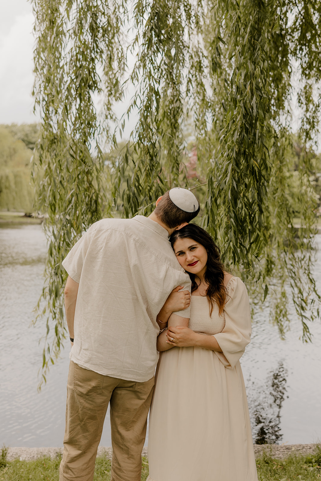 Beautiful couple pose together in a Boston garden, a perfect Boston engagement location