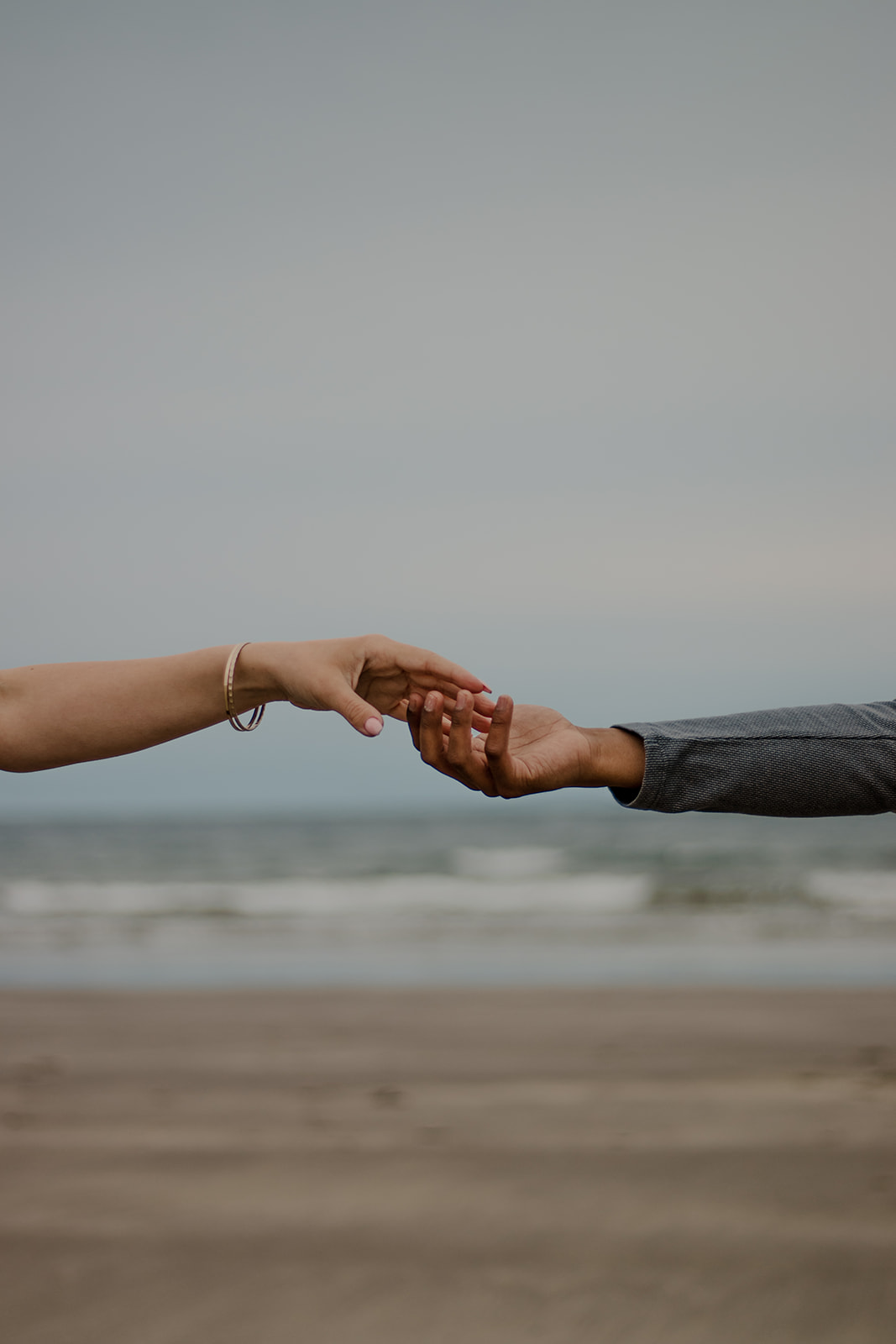 beautiful couple poses on a Boston beach for their dreamy engagement photo shoot