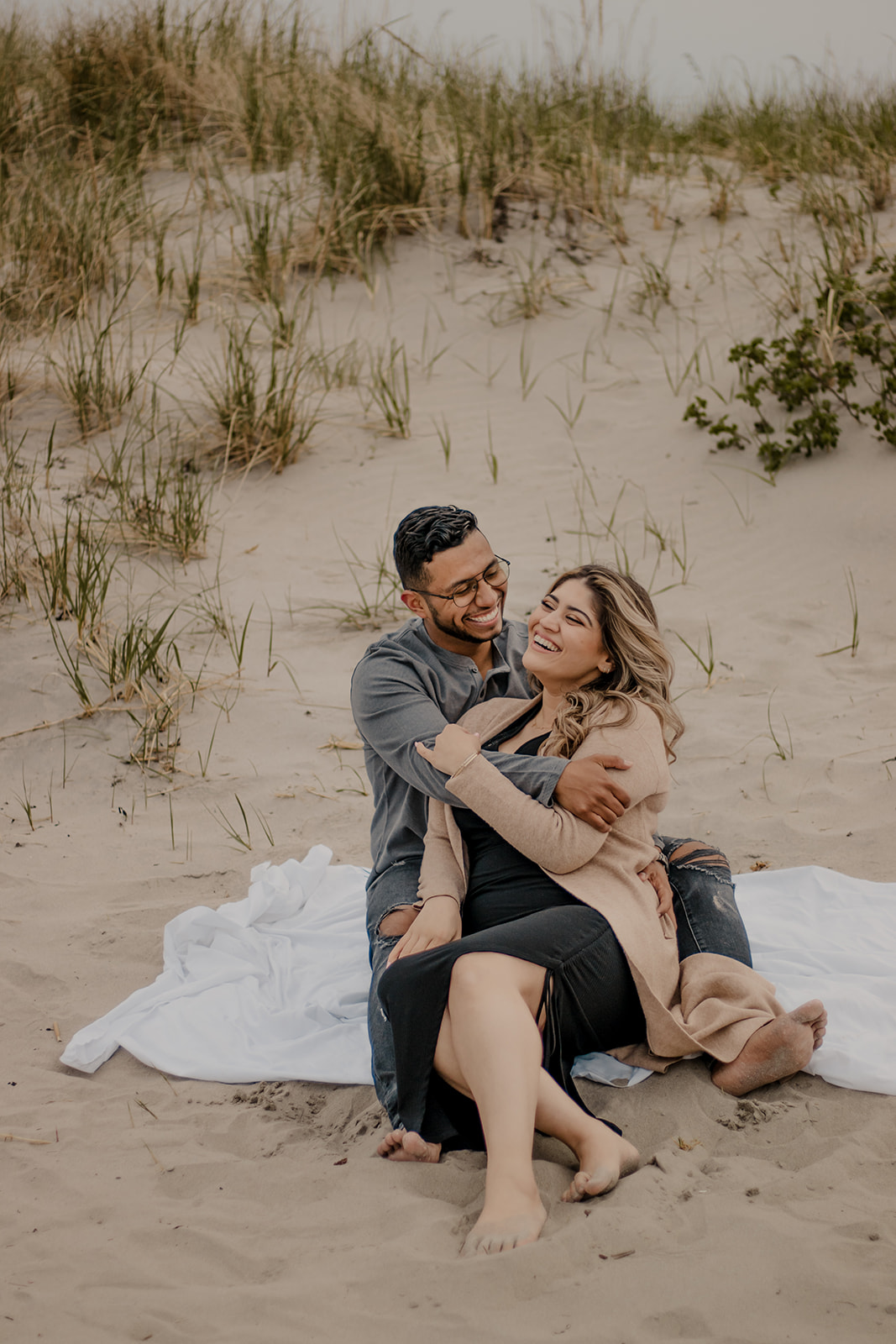 beautiful couple poses on a Boston beach for their dreamy engagement photo shoot