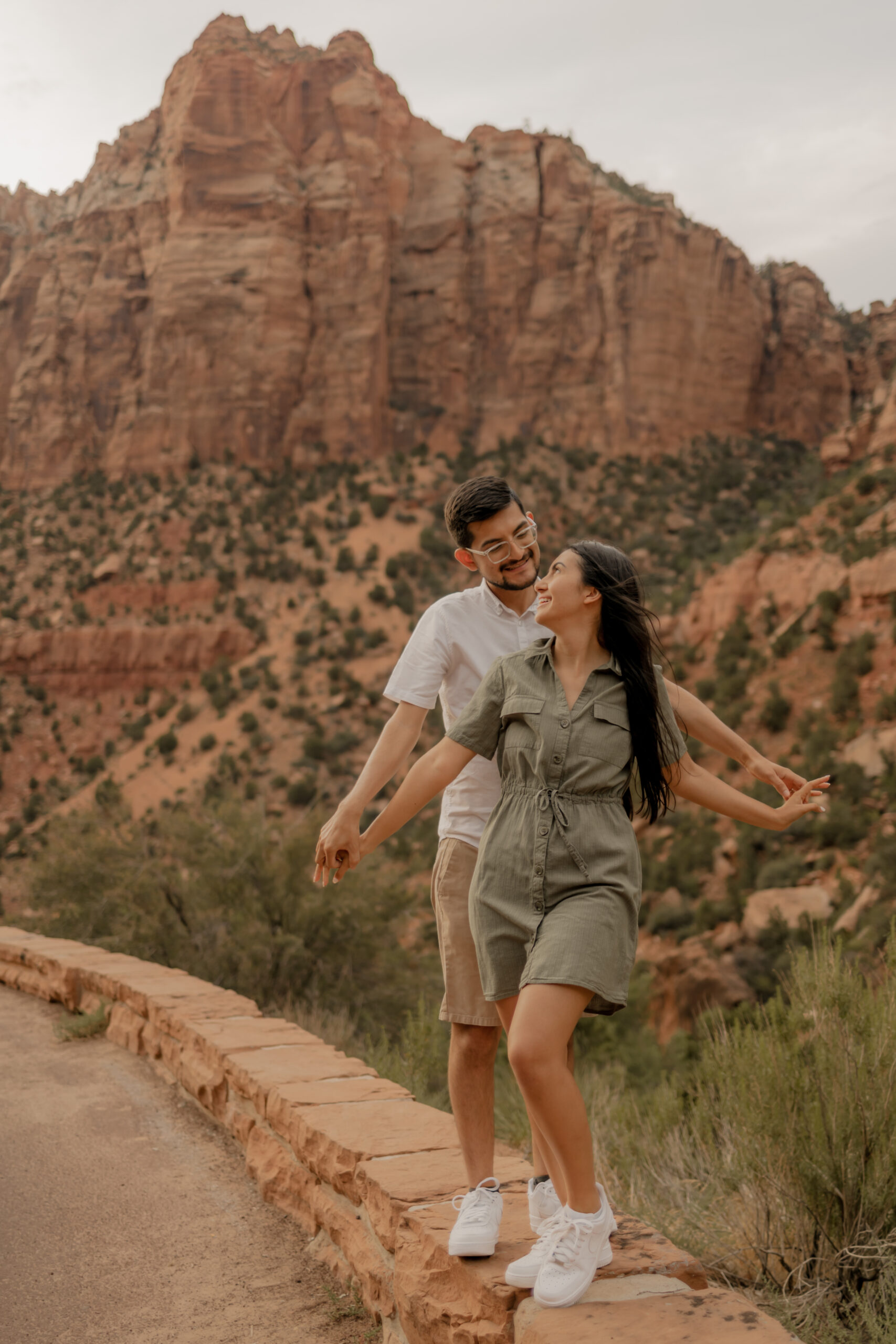 beautiful couple poses with the desert in the background