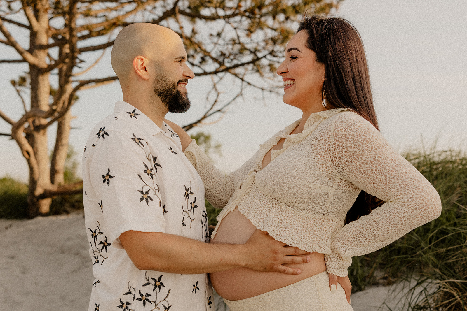 beautiful couple pose together during their East Coast beach maternity photoshoot