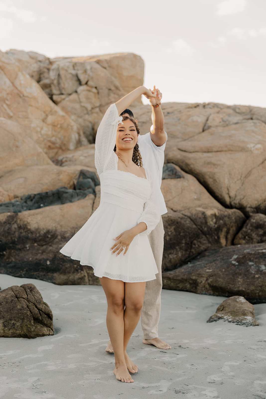 couple dance together on a beach