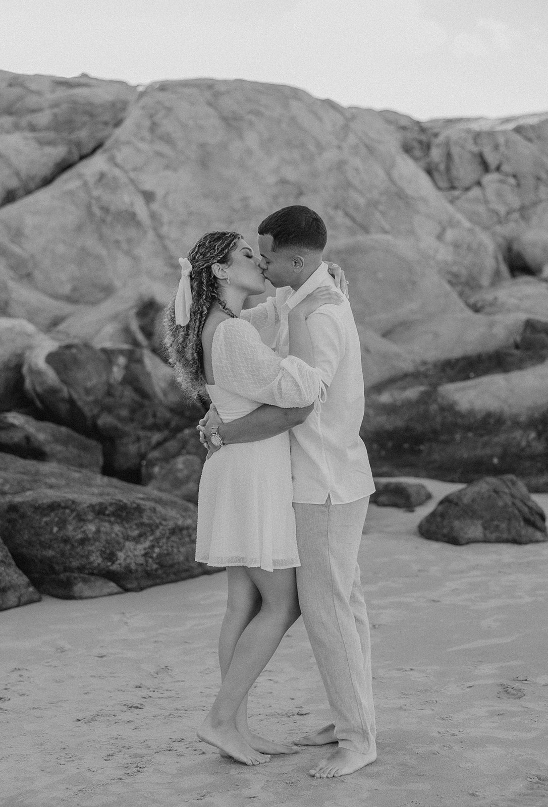 beautiful couple share a romantic pose on a beach during their New England engagement photos