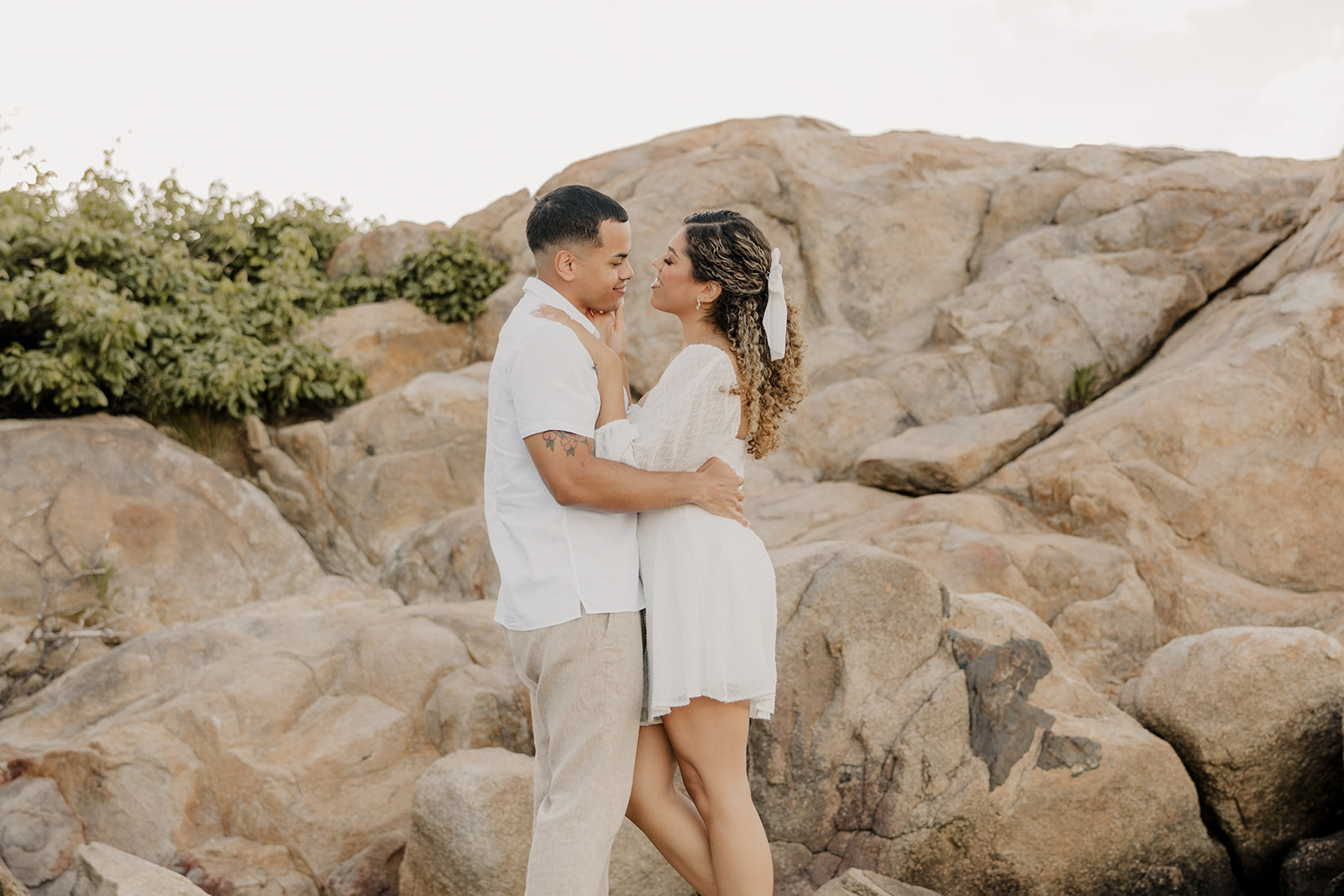 beautiful couple share a romantic pose on a beach during their New England engagement photos