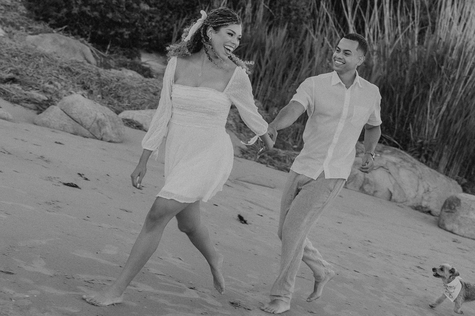 beautiful couple walk on the beach together during their New England beach engagement photoshoot