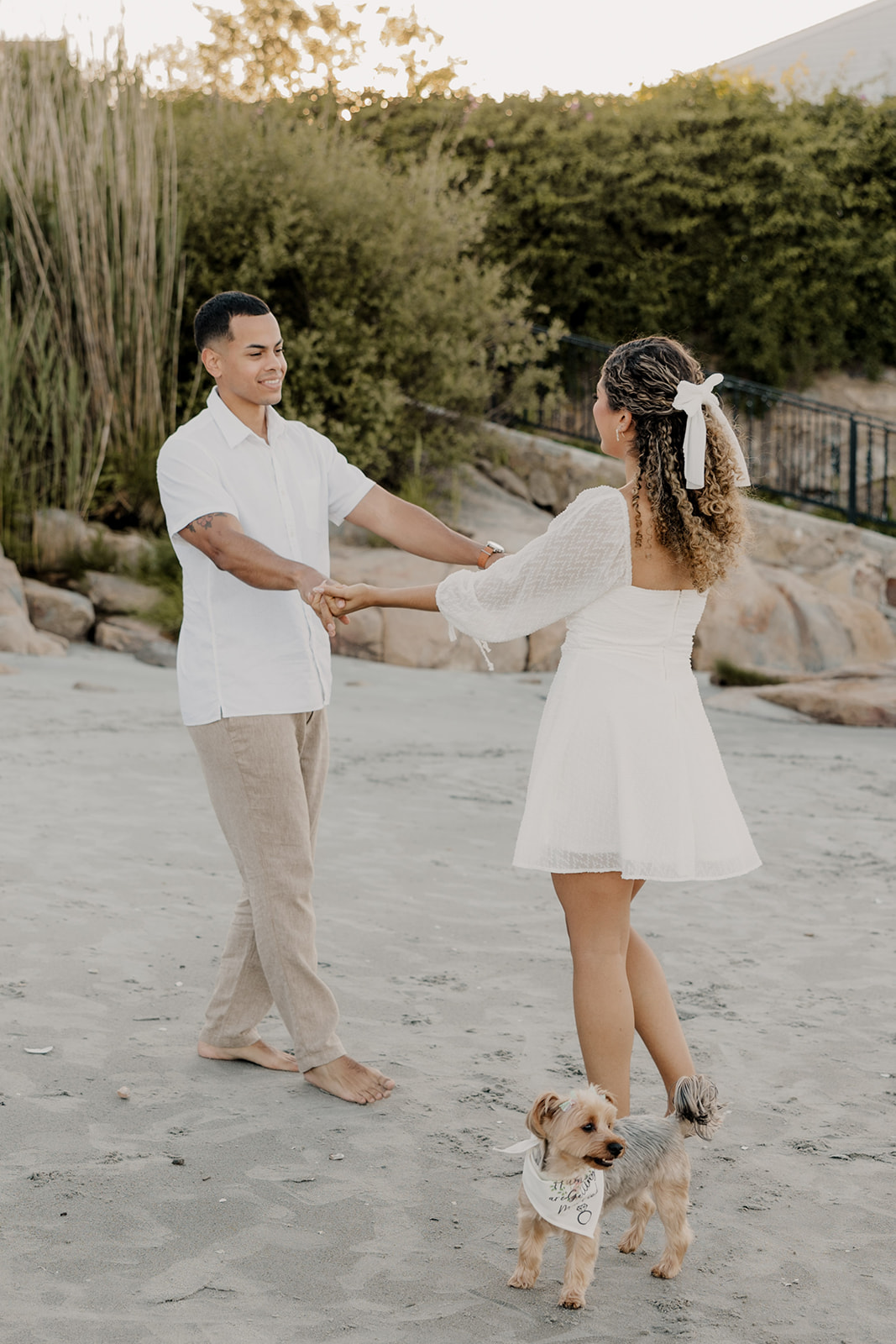 couple dance together on a beach