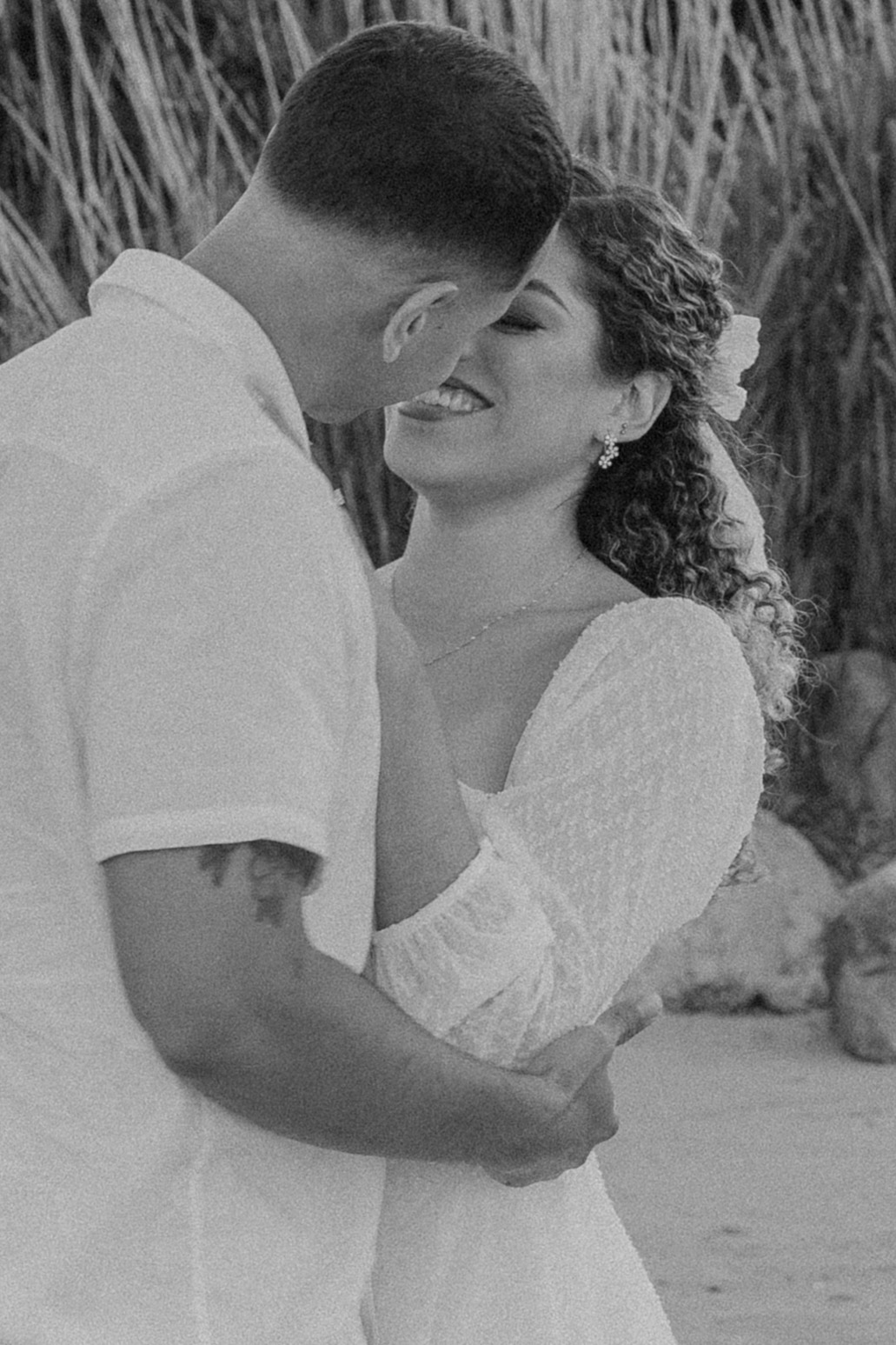 beautiful couple share a romantic pose on a beach during their New England engagement photos