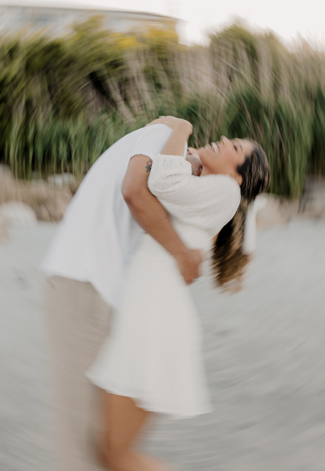 beautiful couple pose on the beach together during their New England beach engagement photoshoot