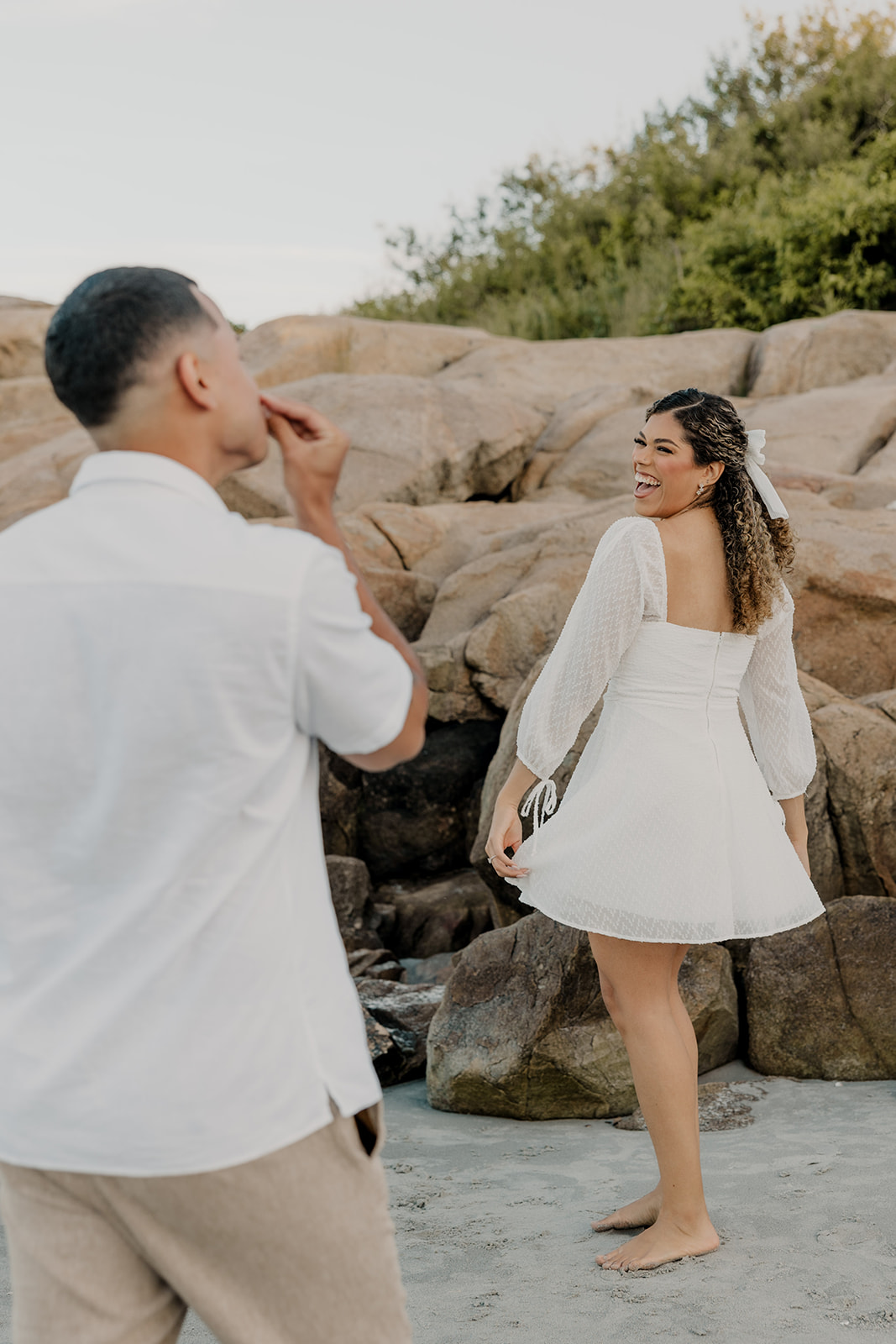 beautiful couple pose on the beach together during their New England beach engagement photoshoot