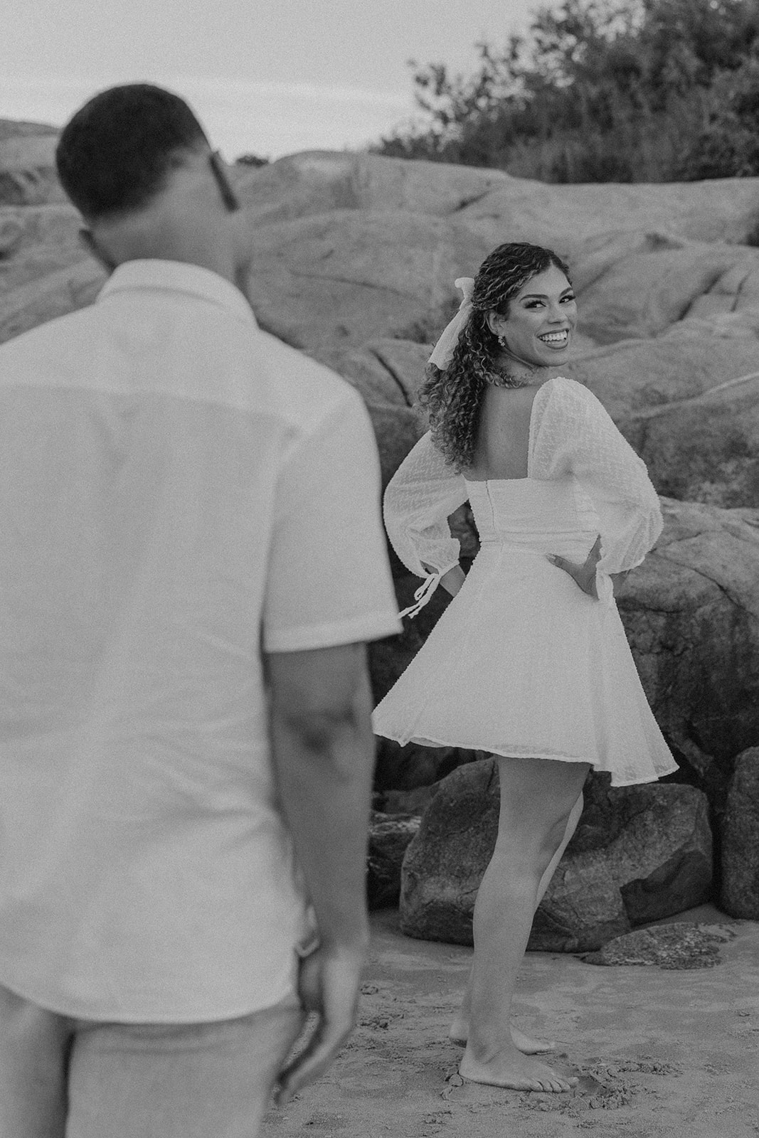 beautiful couple pose on the beach together during their New England beach engagement photoshoot