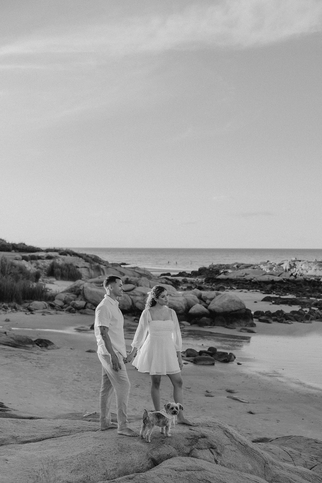 beautiful couple pose on the beach together during their New England beach engagement photoshoot