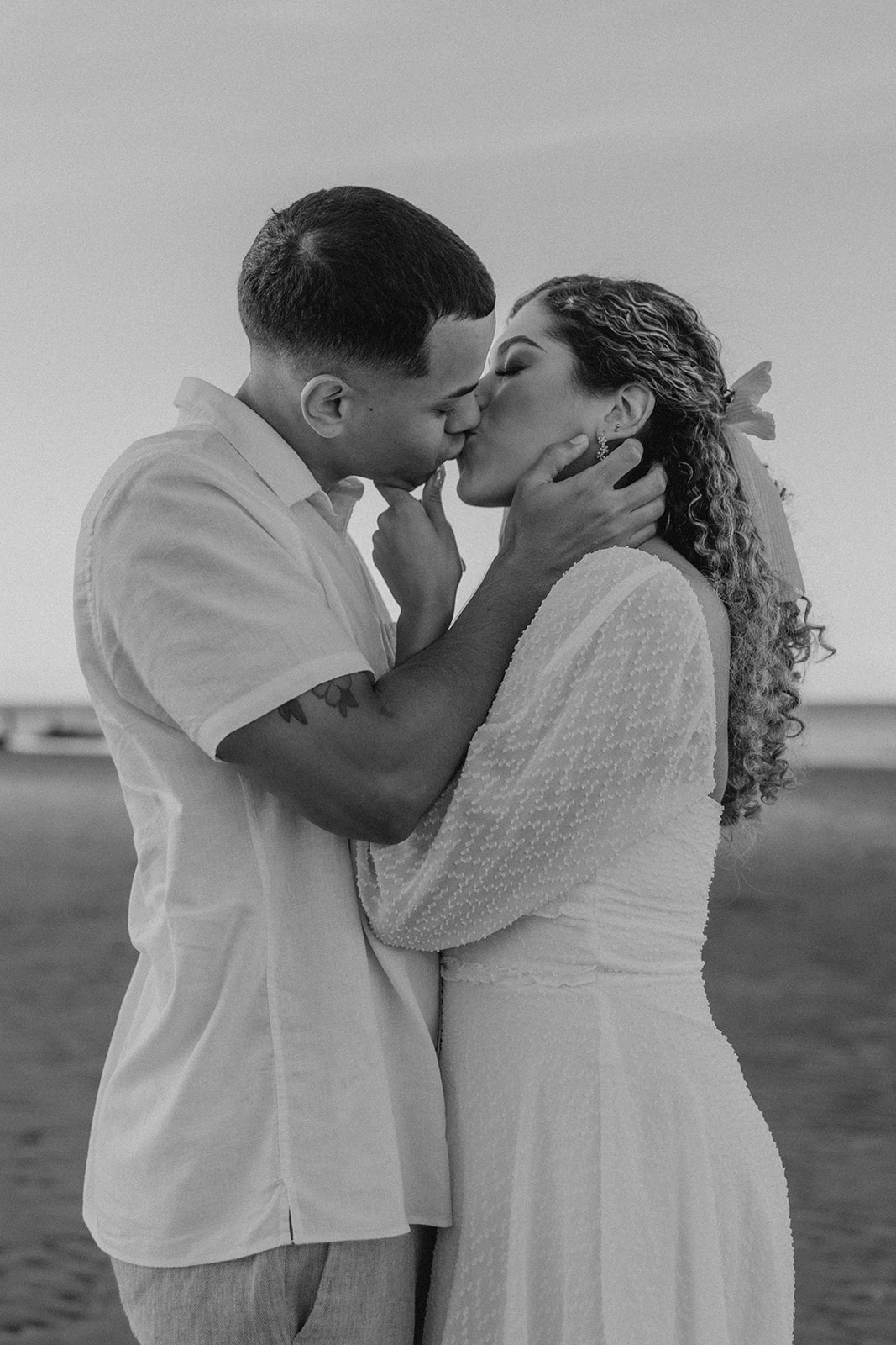 beautiful couple share a romantic pose on a beach during their New England engagement photos