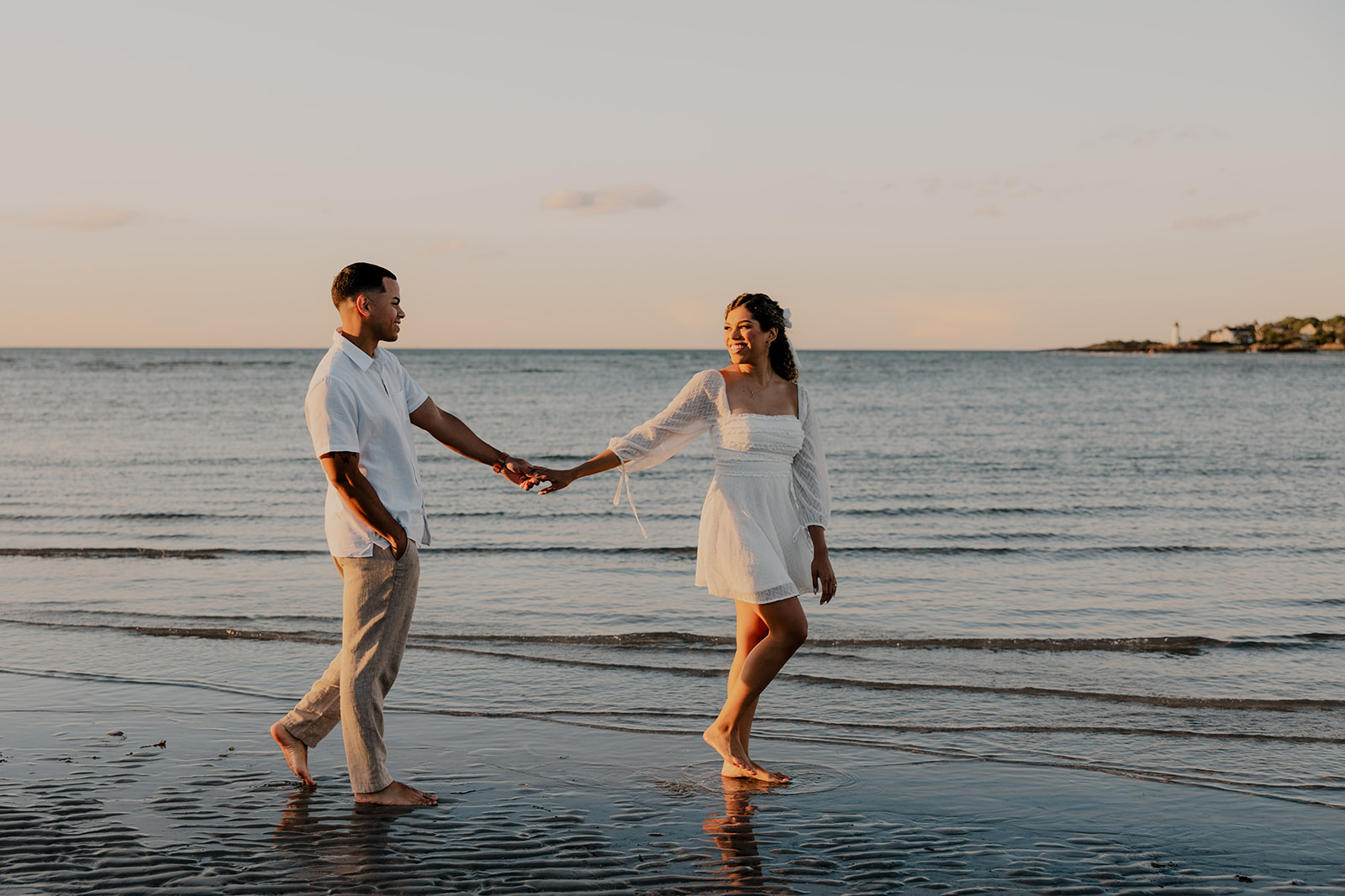 beautiful couple pose on the beach together during their New England beach engagement photoshoot