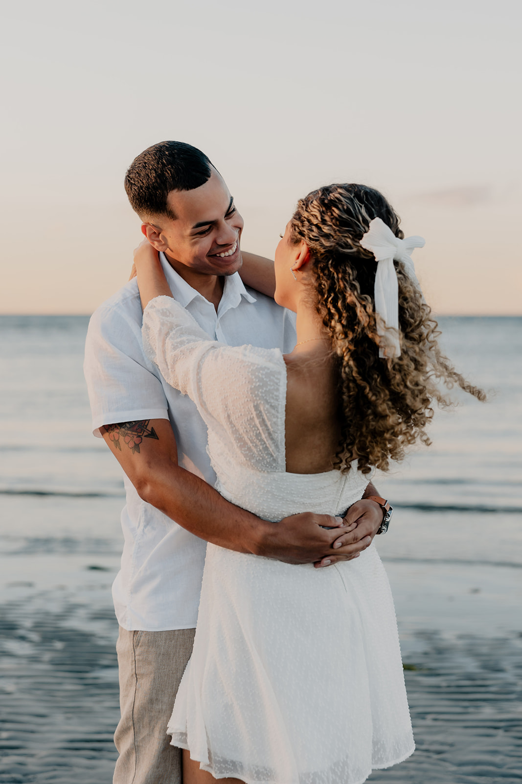 beautiful couple share a romantic pose during golden hour