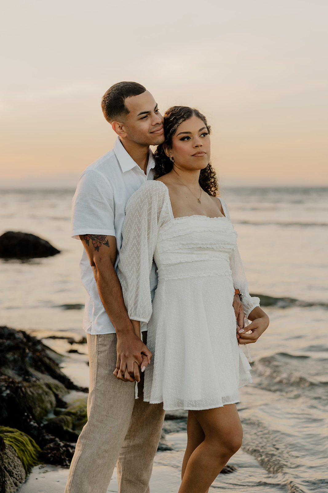 beautiful couple share a romantic pose during golden hour