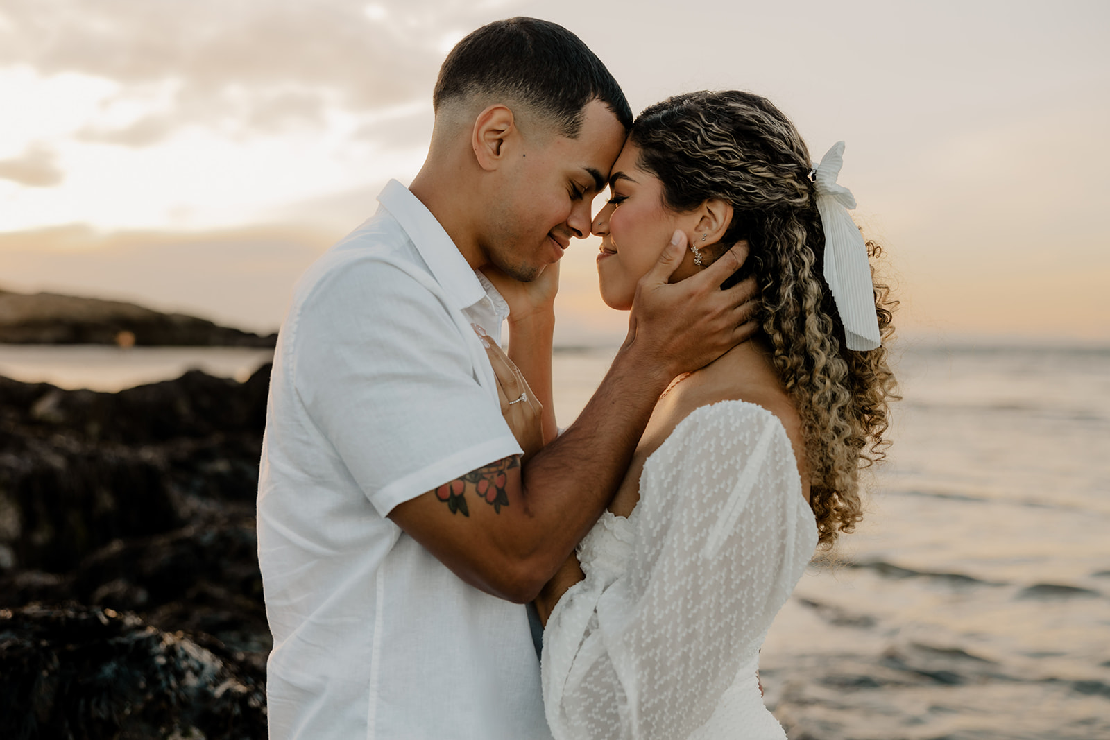 beautiful couple share a romantic pose on a beach during their New England engagement photos