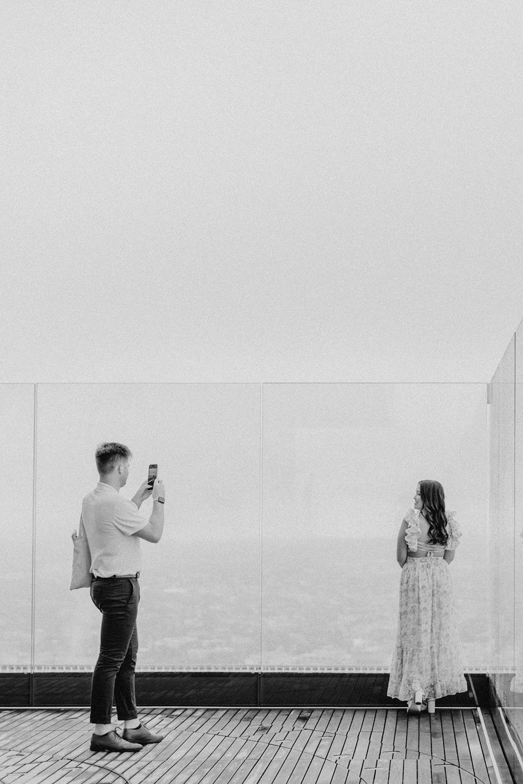 beautiful couple pose together during their surprise proposal at The View in Boston