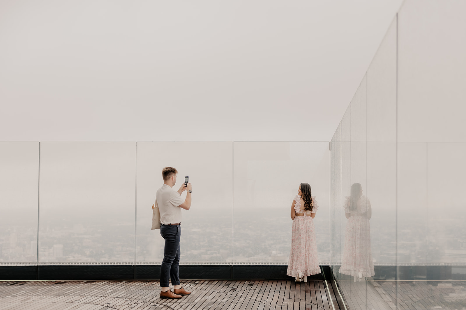 beautiful couple pose together during their surprise proposal at The View in Boston