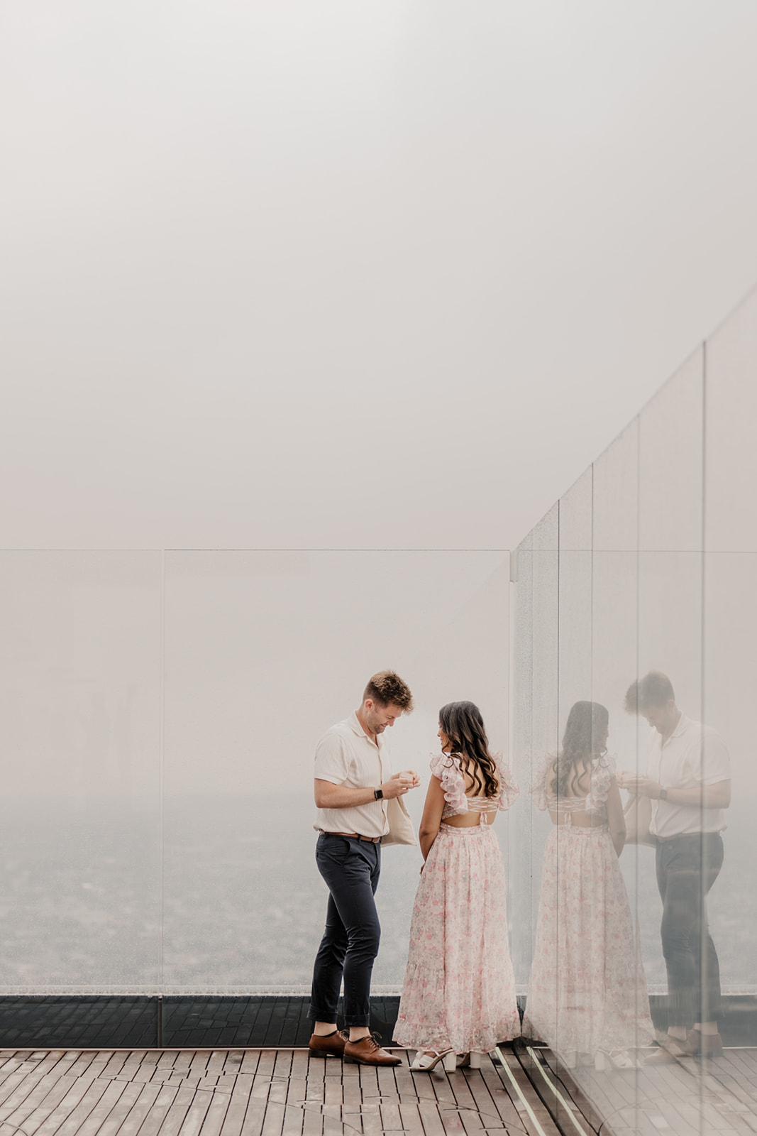 beautiful couple pose together during their surprise proposal at The View in Boston