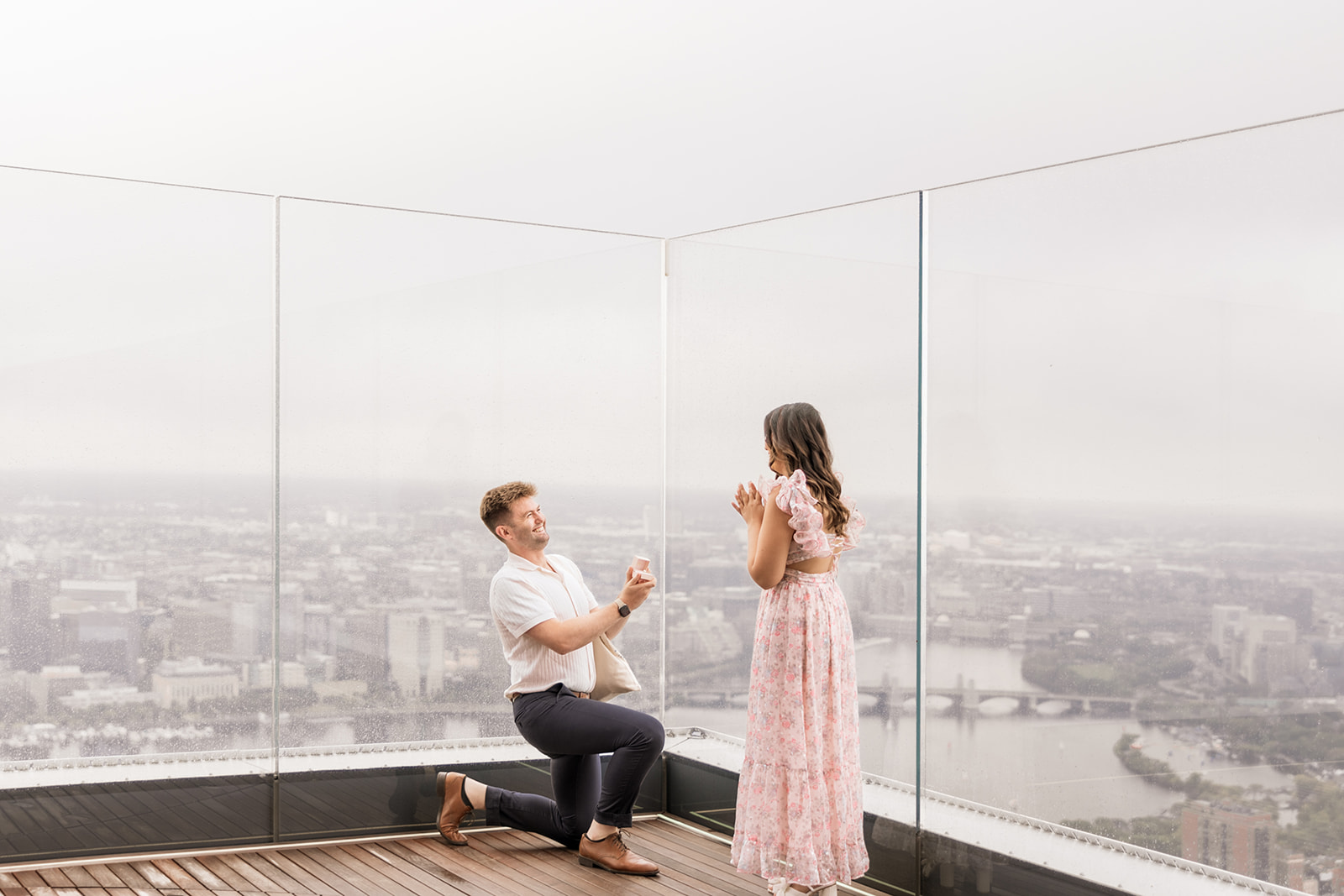 beautiful couple pose together during their surprise proposal at The View in Boston