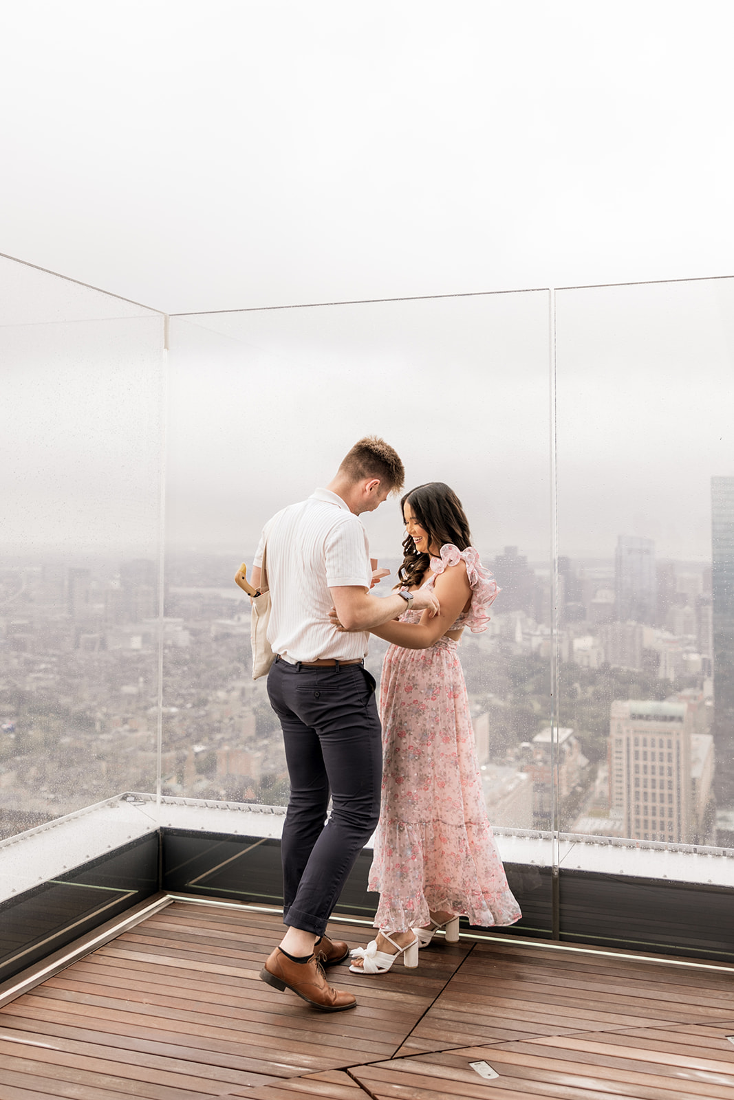 beautiful couple pose together during their surprise proposal at The View in Boston