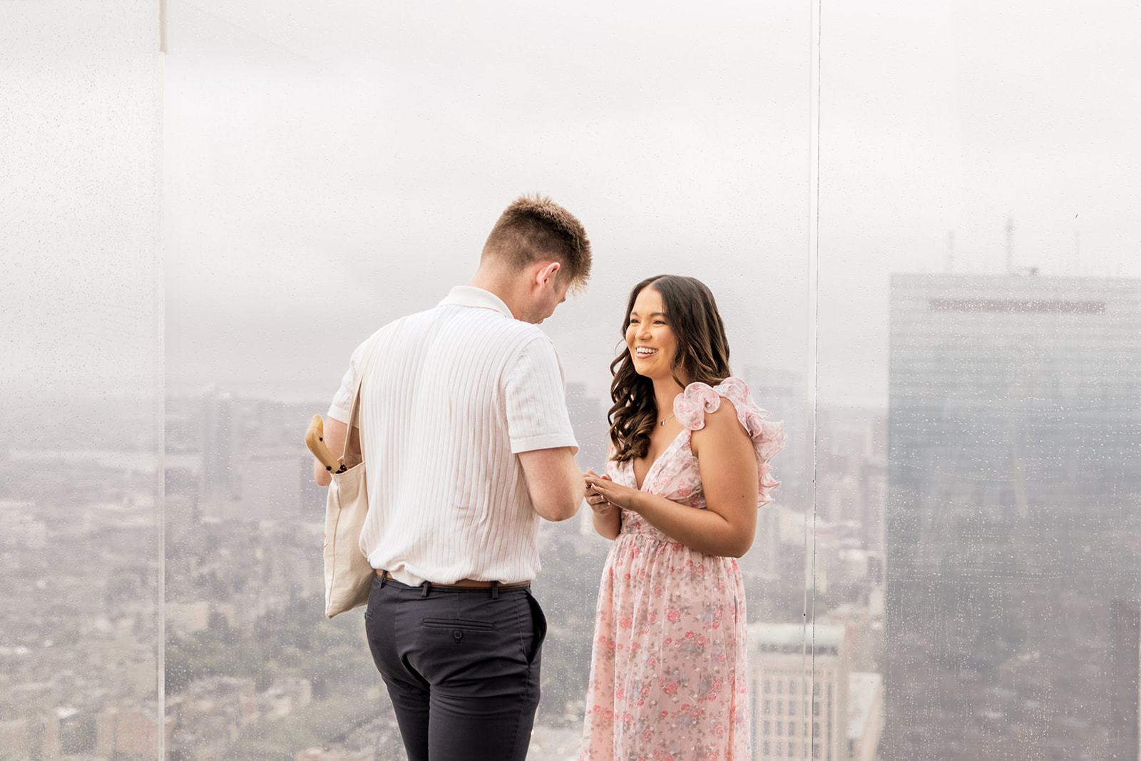 beautiful couple pose together during their surprise proposal at The View in Boston