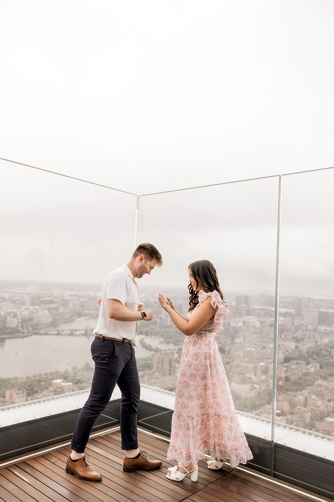 beautiful couple pose together during their surprise proposal at The View in Boston