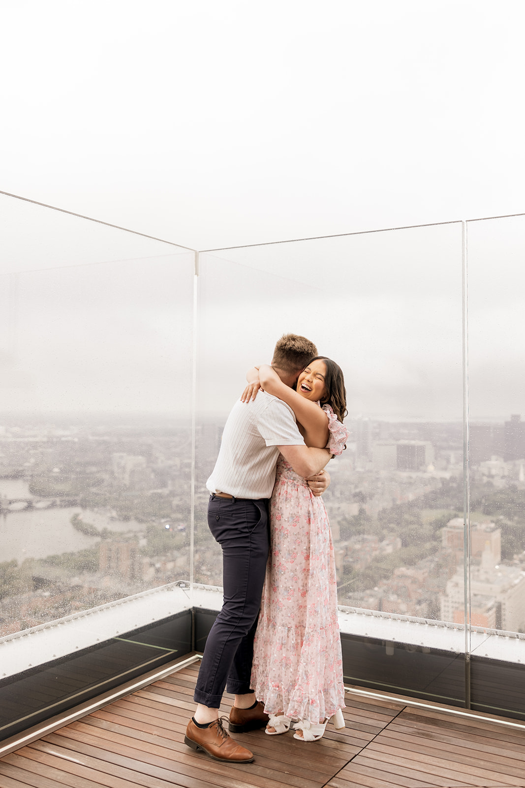 beautiful couple pose together during their surprise proposal at The View in Boston