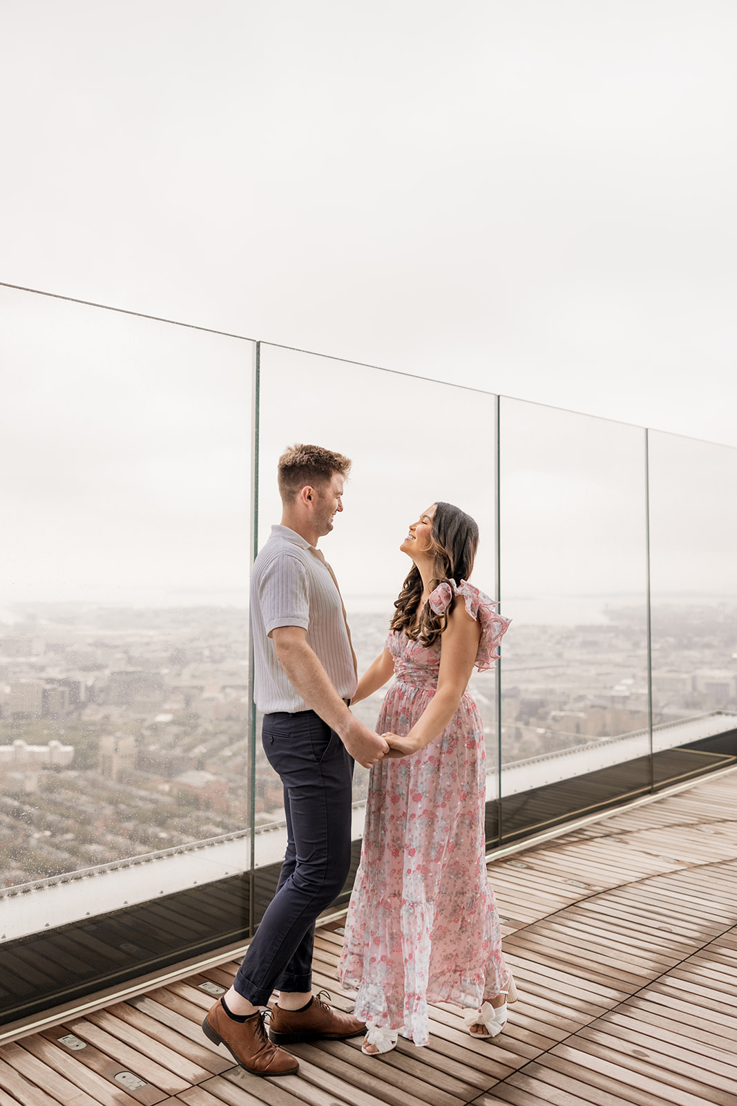 beautiful couple pose together during their surprise proposal at The View in Boston