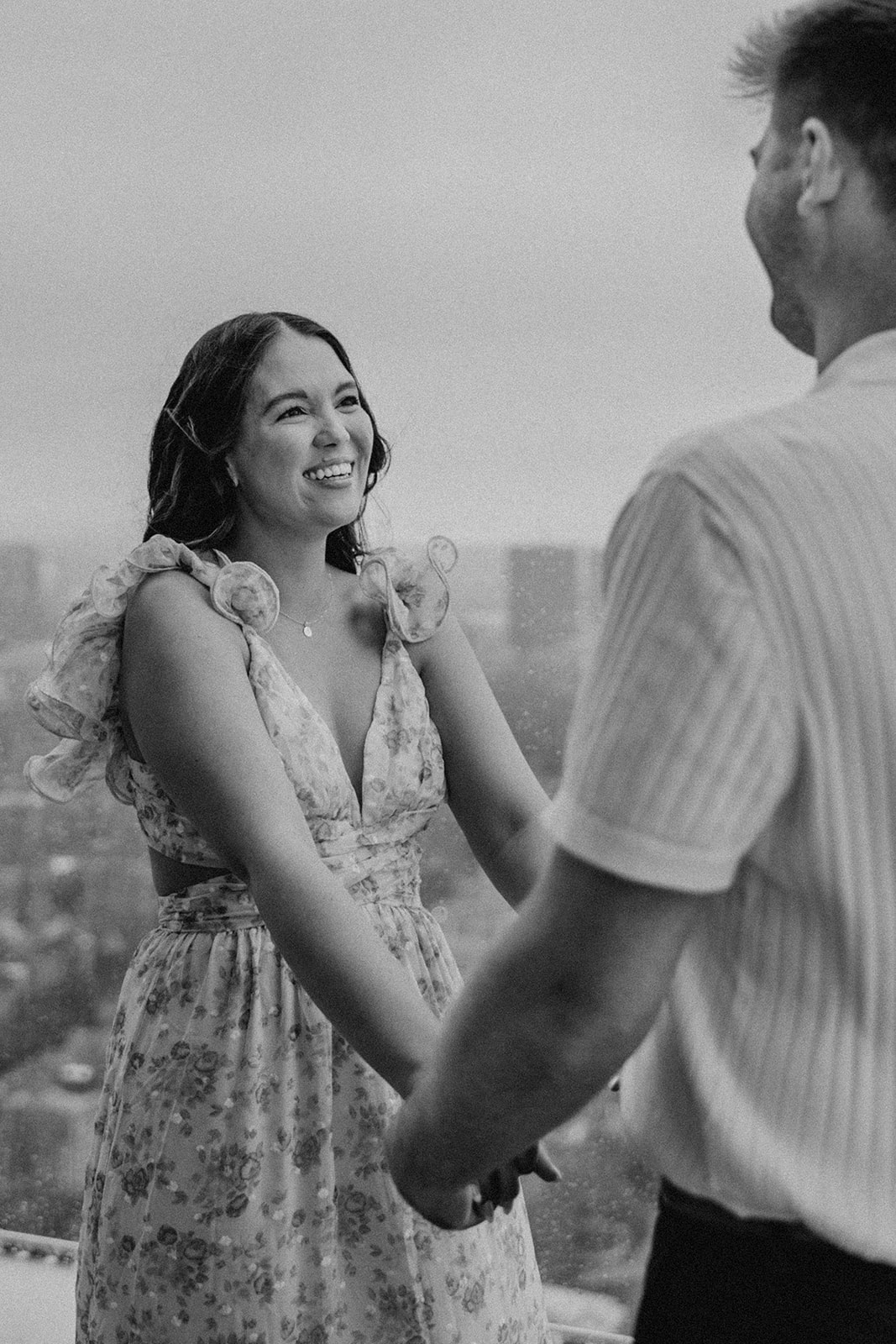 beautiful couple pose together during their surprise proposal at The View in Boston