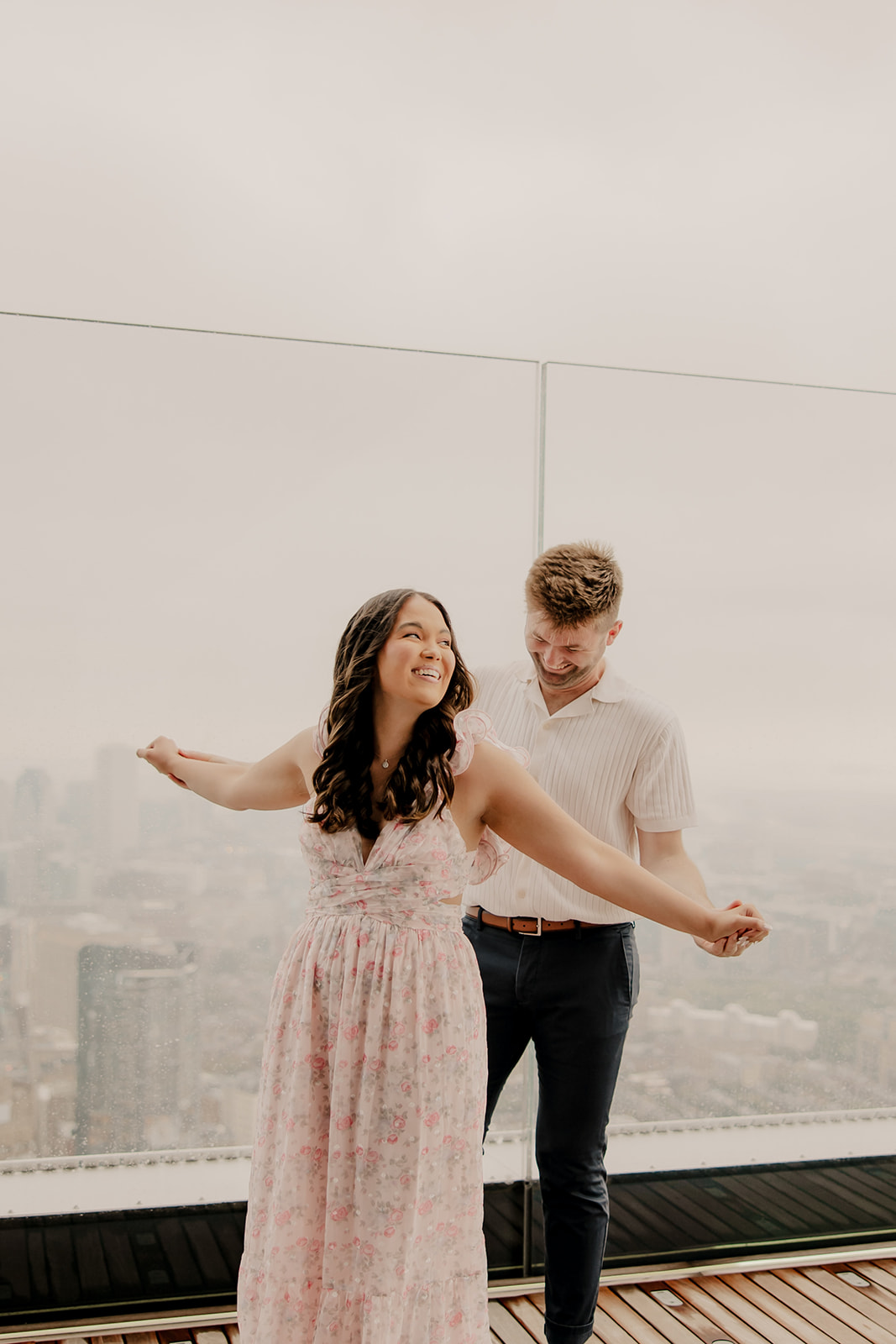 beautiful couple pose together during their surprise proposal at The View in Boston