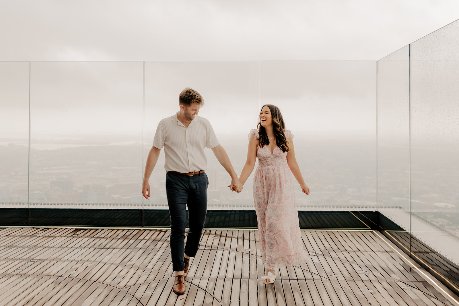 beautiful couple pose together during their surprise proposal at The View in Boston