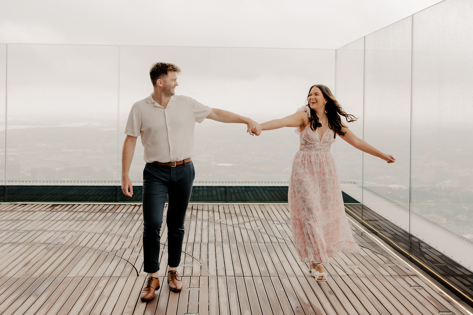 beautiful couple pose together during their surprise proposal at The View in Boston