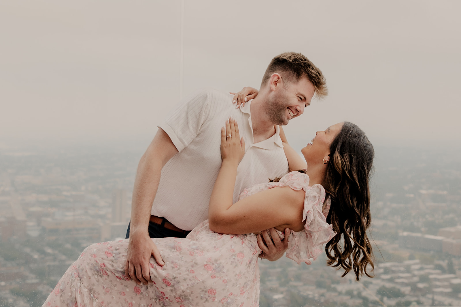 beautiful couple pose together during their surprise proposal at The View in Boston