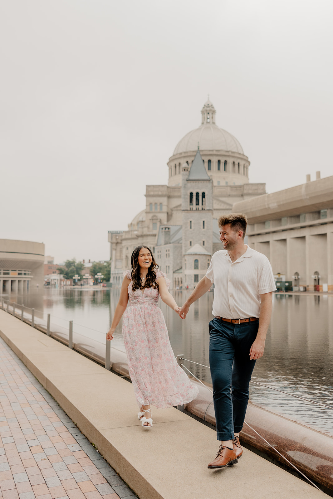 stunning couple walk together along the reflecting pond