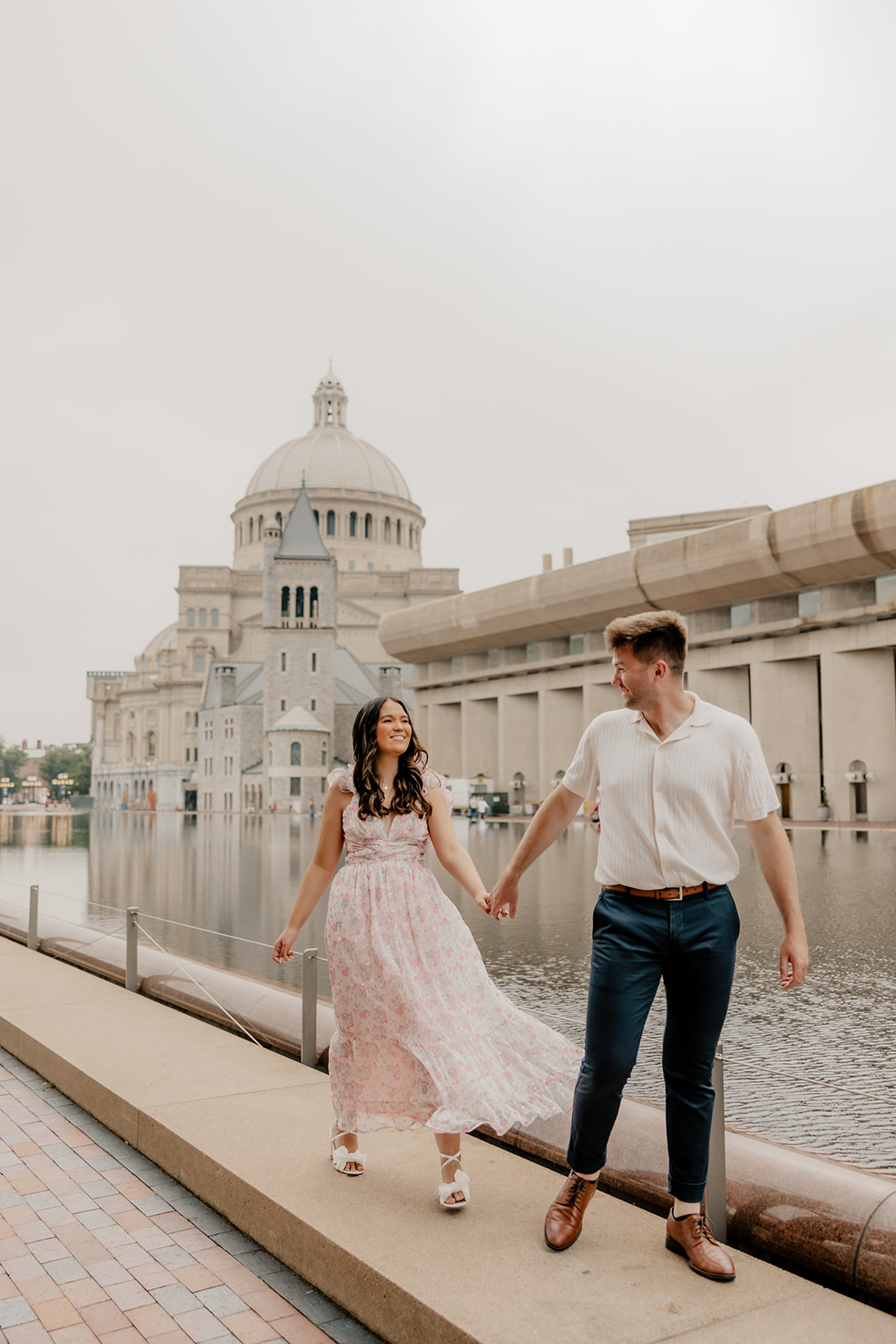 stunning couple walk together along the reflecting pond