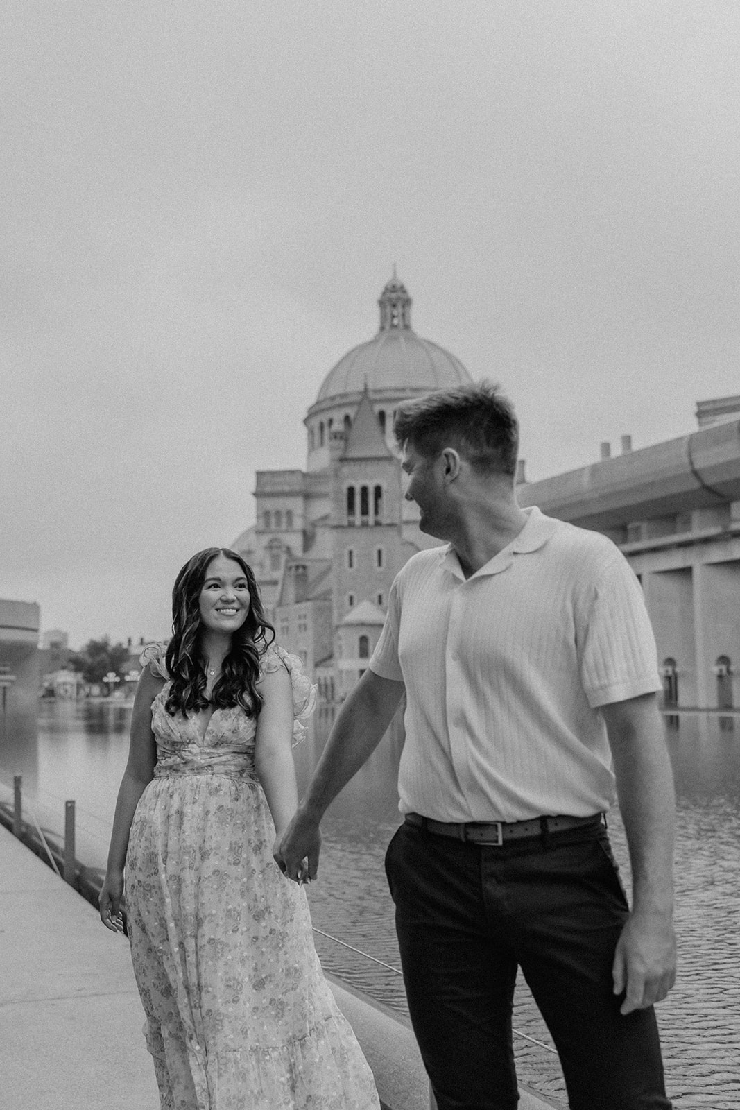 stunning couple walk together along the reflecting pond