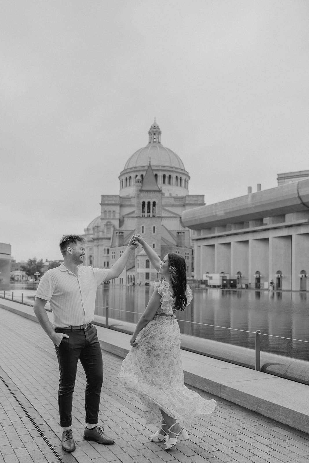 stunning couple walk together along the reflecting pond