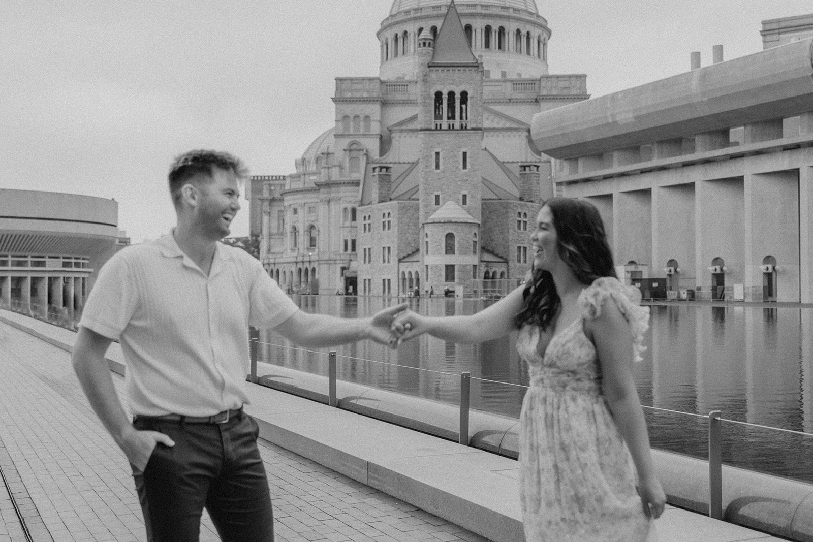 stunning couple walk together along the reflecting pond