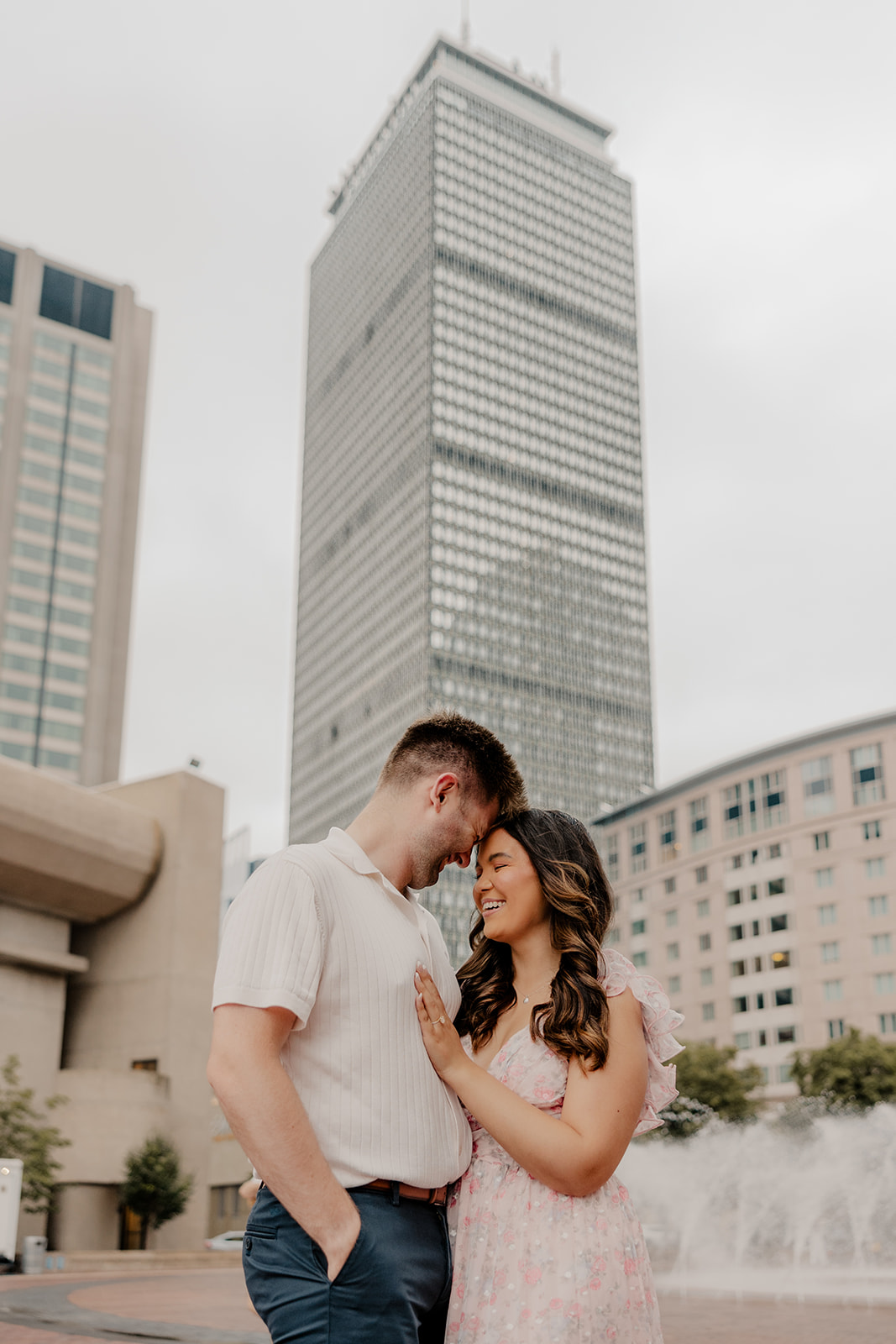 beautiful couple share an intimate moment with Boston in the background